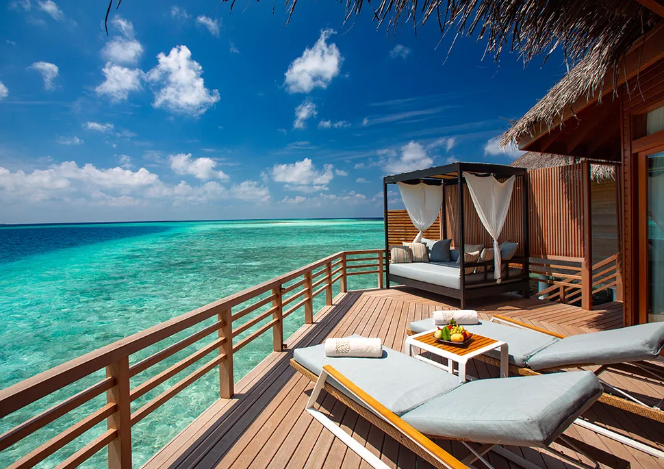 A Water Villa deck with its canopied daybed over the lagoon