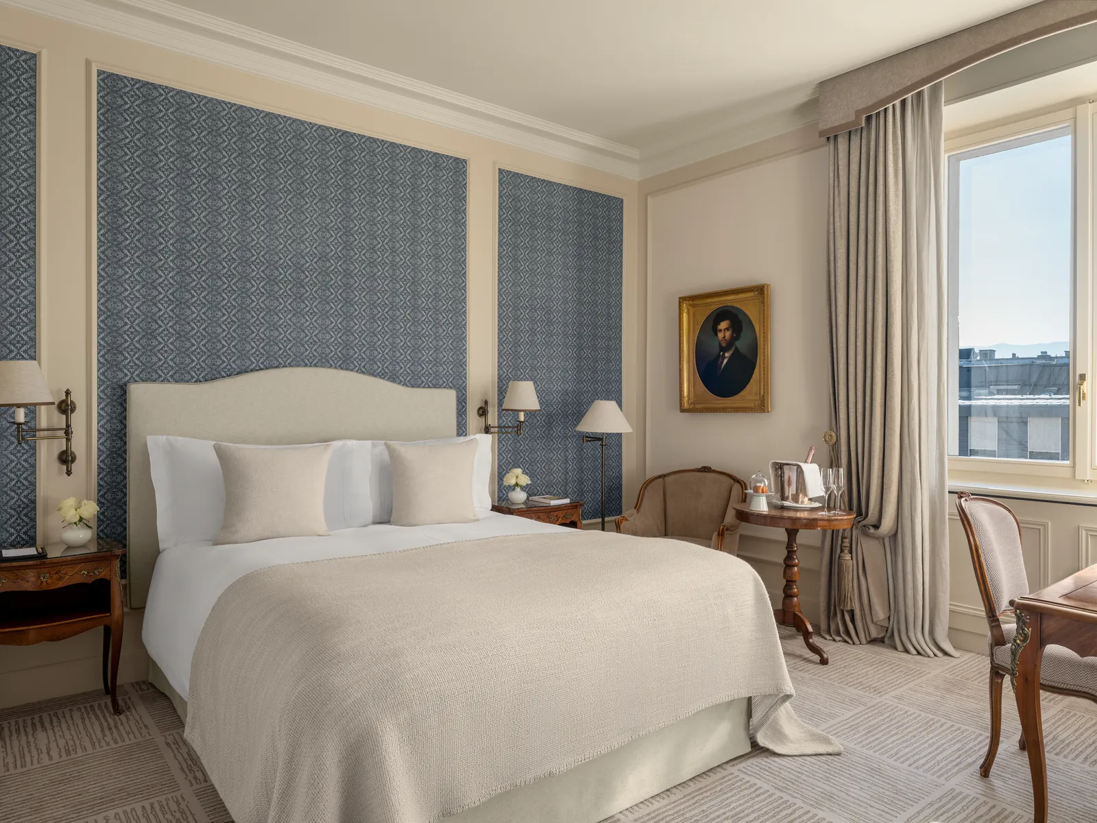A Deluxe Ville View with a blue wall behind the bed