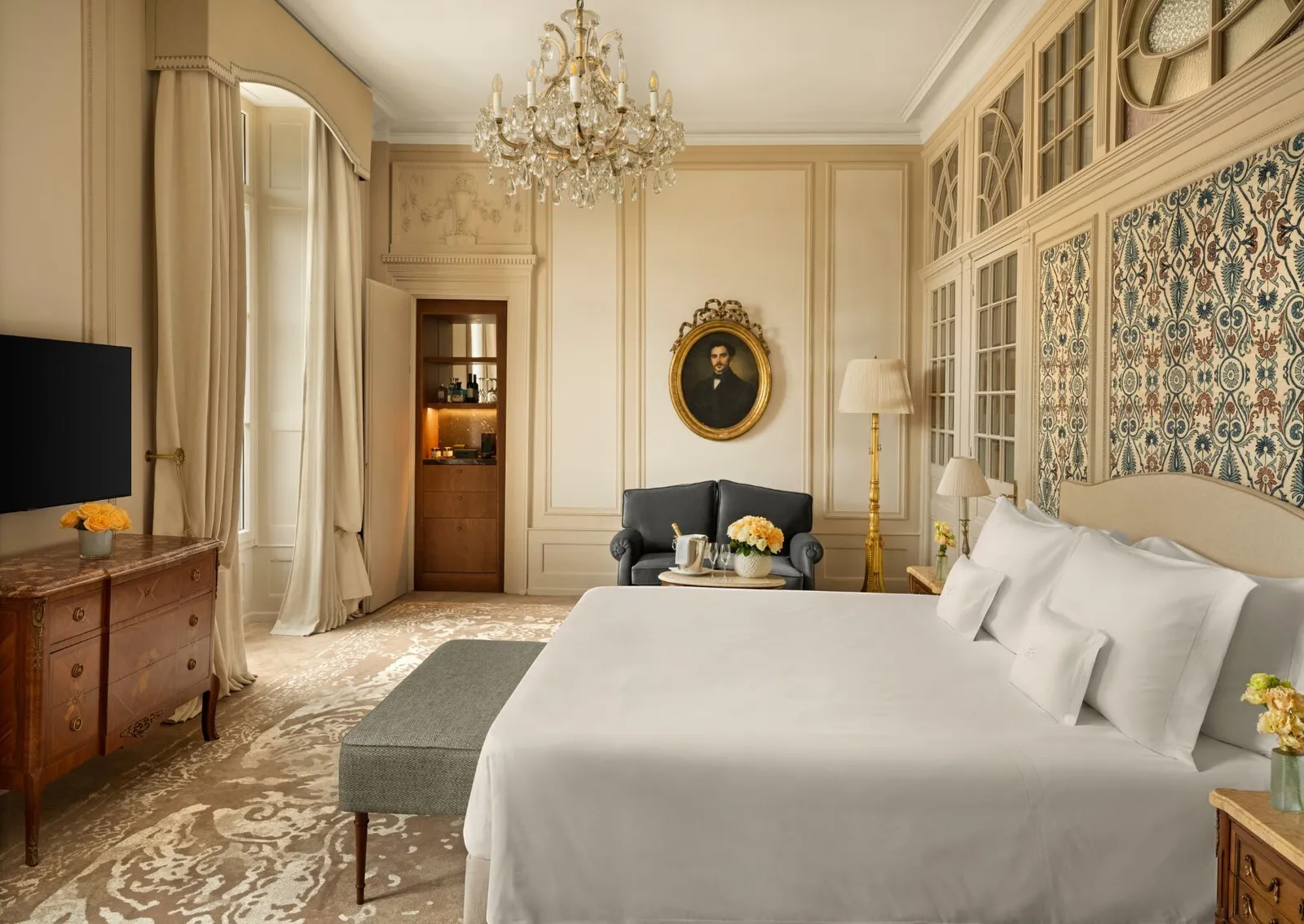The Heritage Suite bedroom, with its panelling and portrait