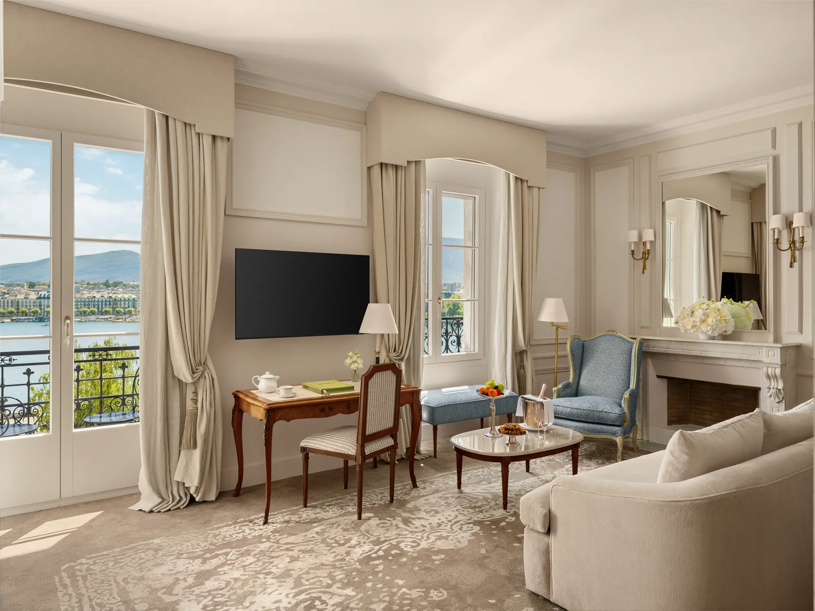 A Prestige Junior Suite Lake View sitting area, with French windows