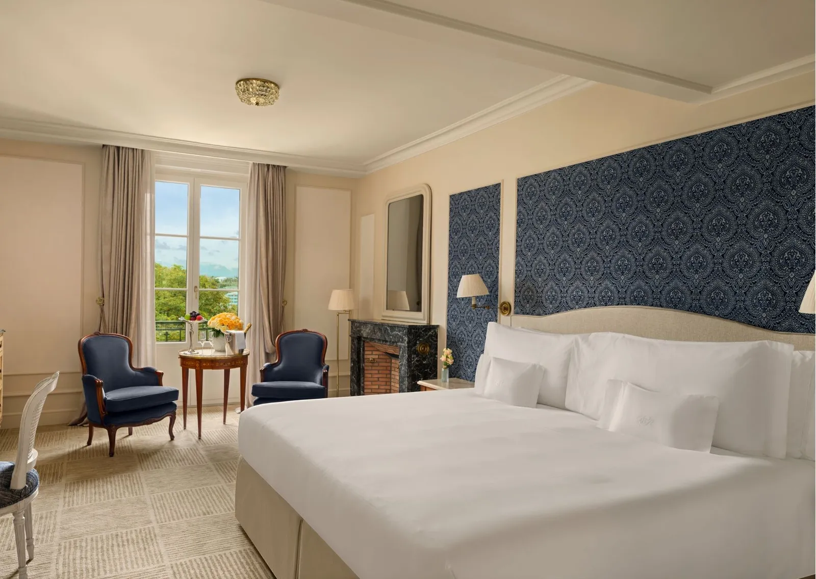 A Prestige Lake View, with blue armchairs by the window