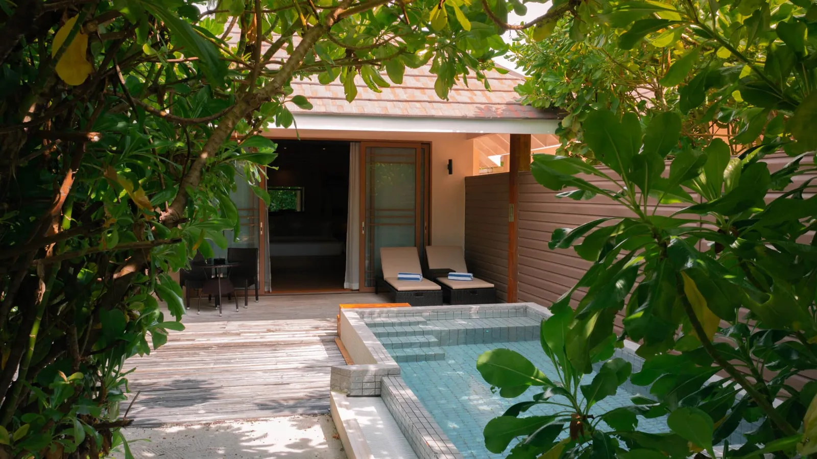 The villa terrace with its pool, among the greenery.