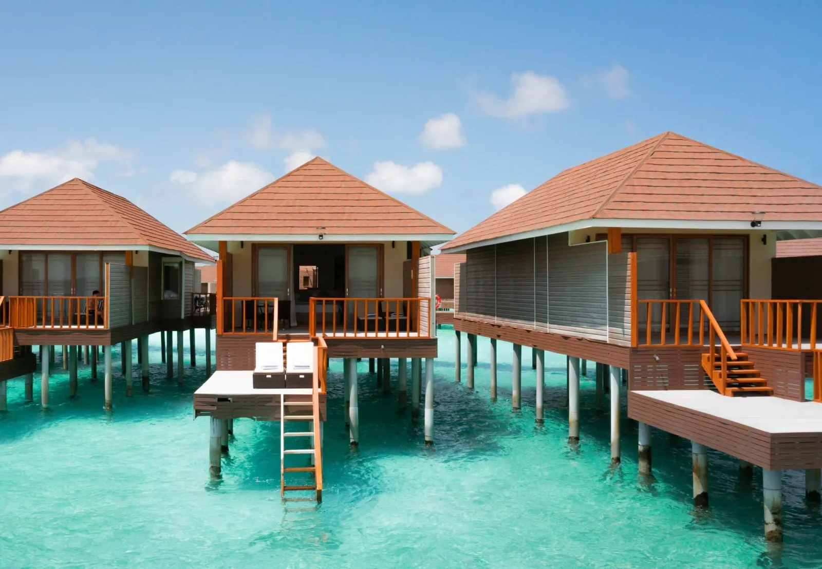 Overwater villas and their terraces above the lagoon.