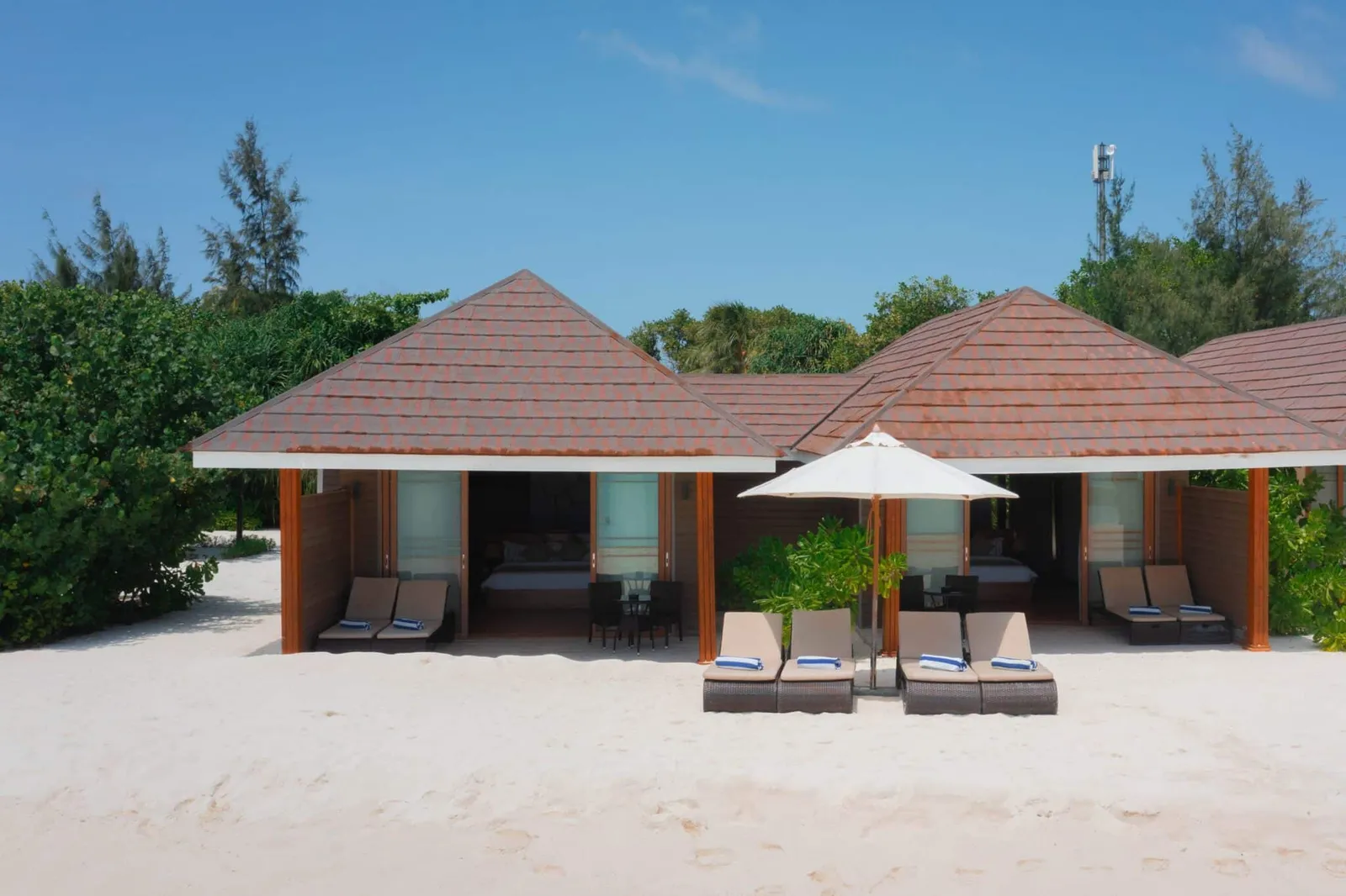 The villa and loungers facing the beach.