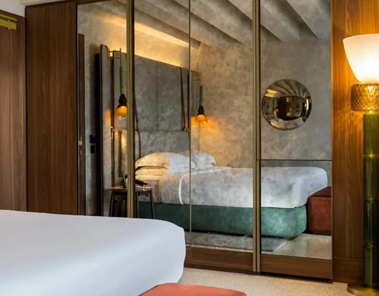 A Deluxe room, with the bed and the mirrored wardrobe