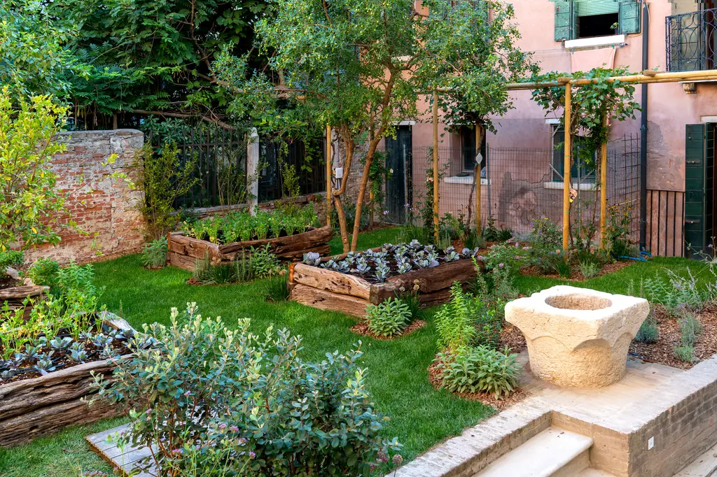 The kitchen garden in one of the courtyards: raised beds and an old stone wellhead