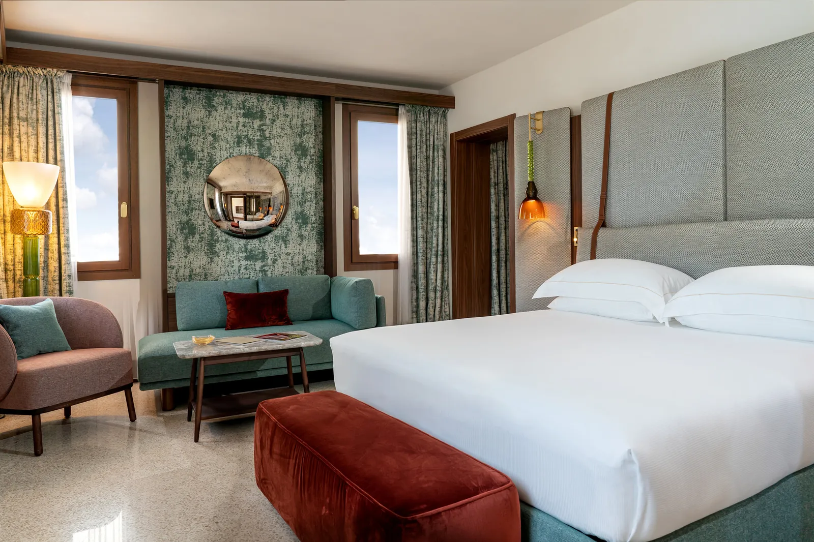 A Lagoon View Suite, with the bed, the sofa and the windows