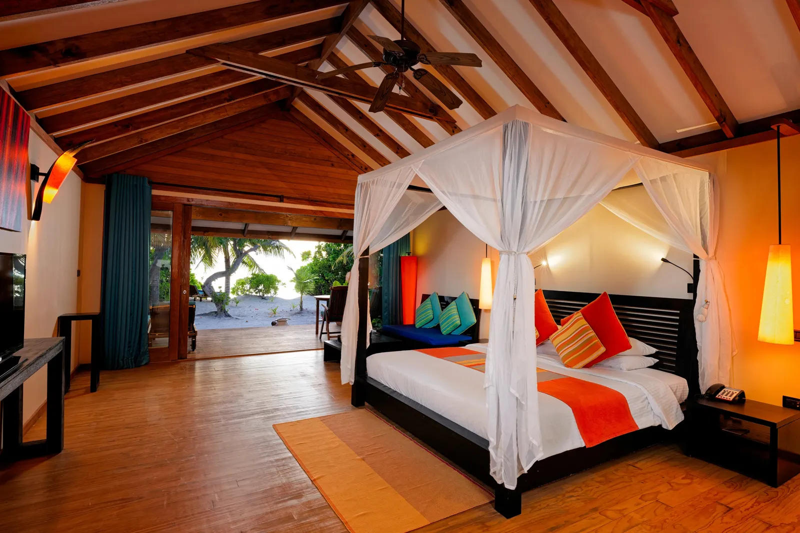 A Premium Beach Villa with Whirlpool bedroom, its four-poster bed
