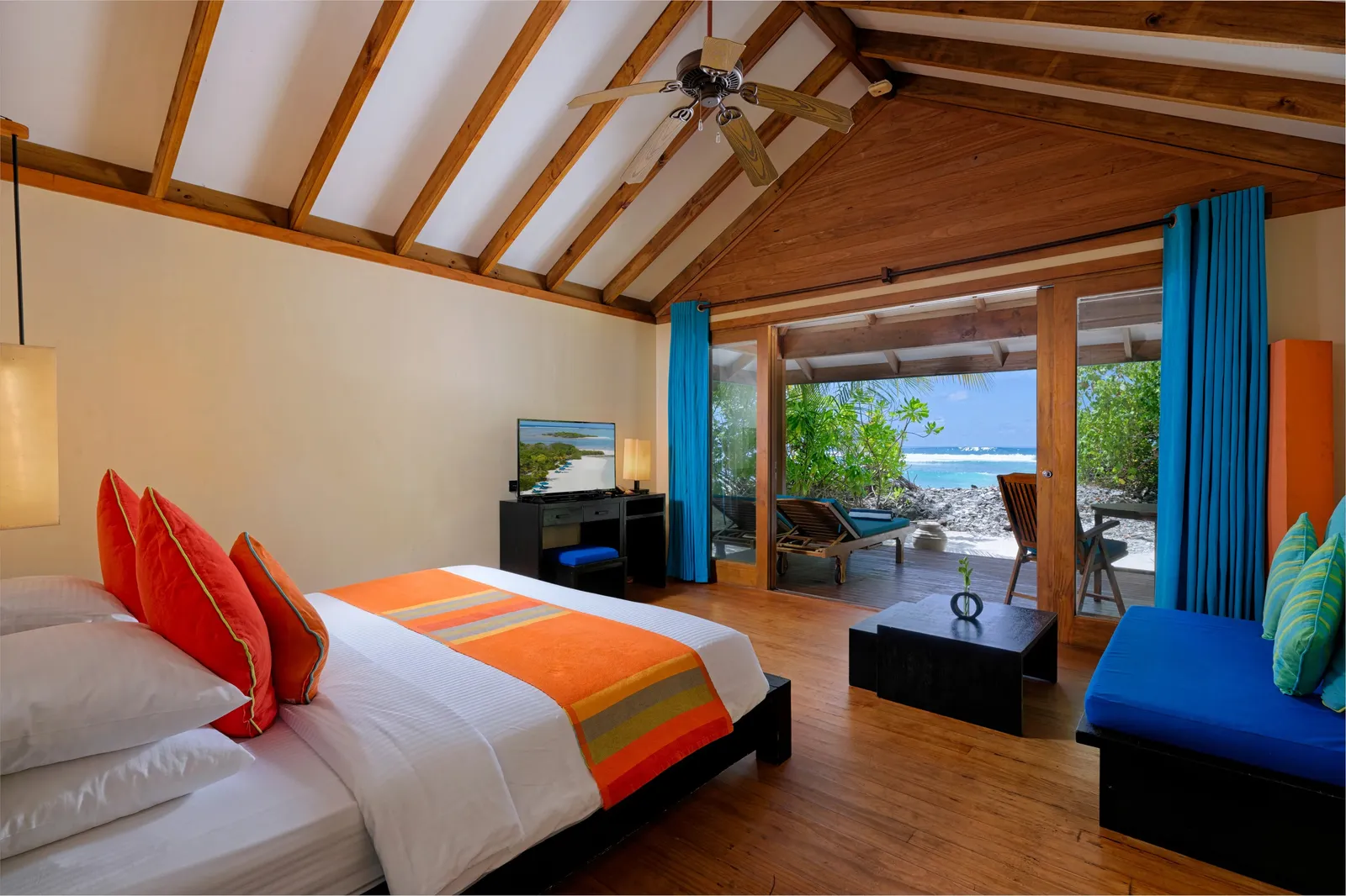 A Sunrise Villa bedroom, open to the terrace and the sea