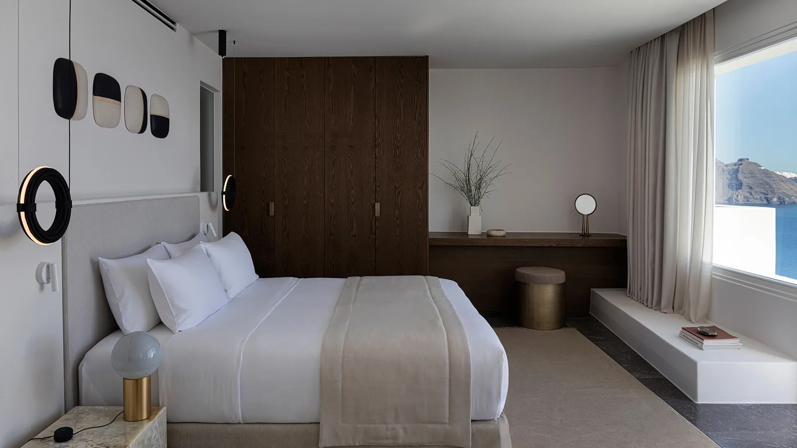 The One Bedroom Pool Villa’s bedroom: the white bed, a dark wood wardrobe and the curtained window.