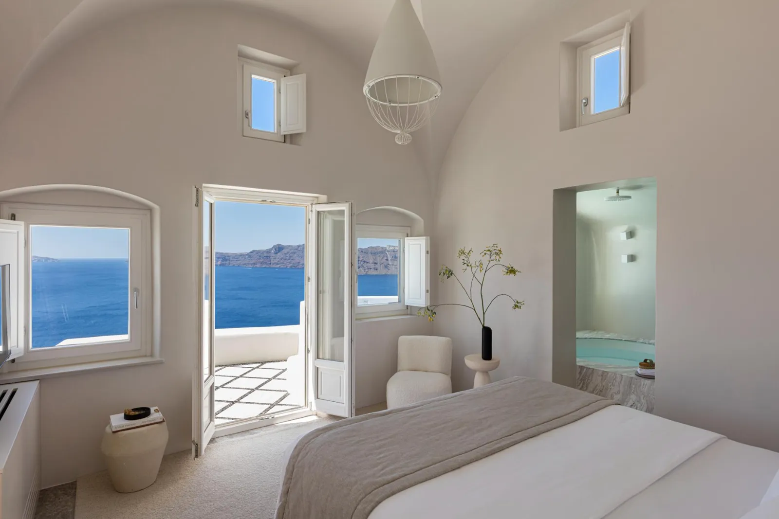 The Presidential Suite’s bedroom: the bed, the vaulted ceiling and the door open onto the terrace and the sea.