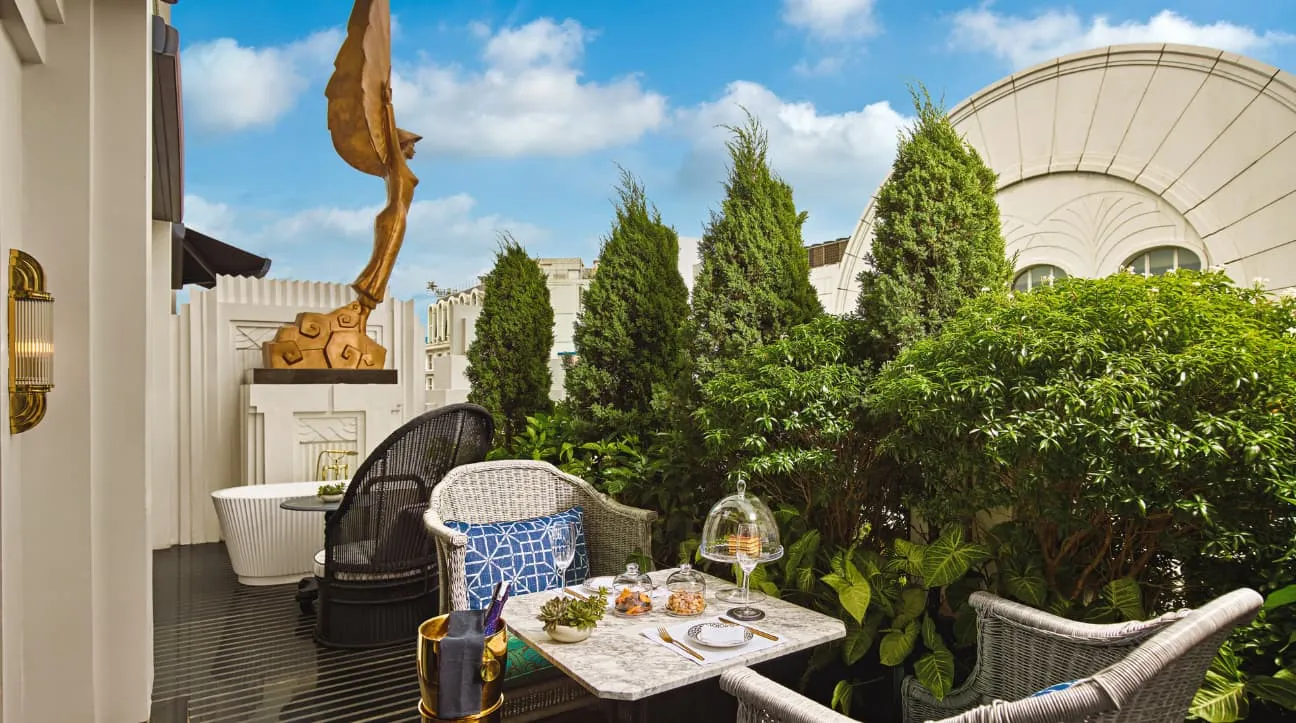 The Royal Opera Suite’s terrace with its outdoor tub, armchairs and a shrub garden