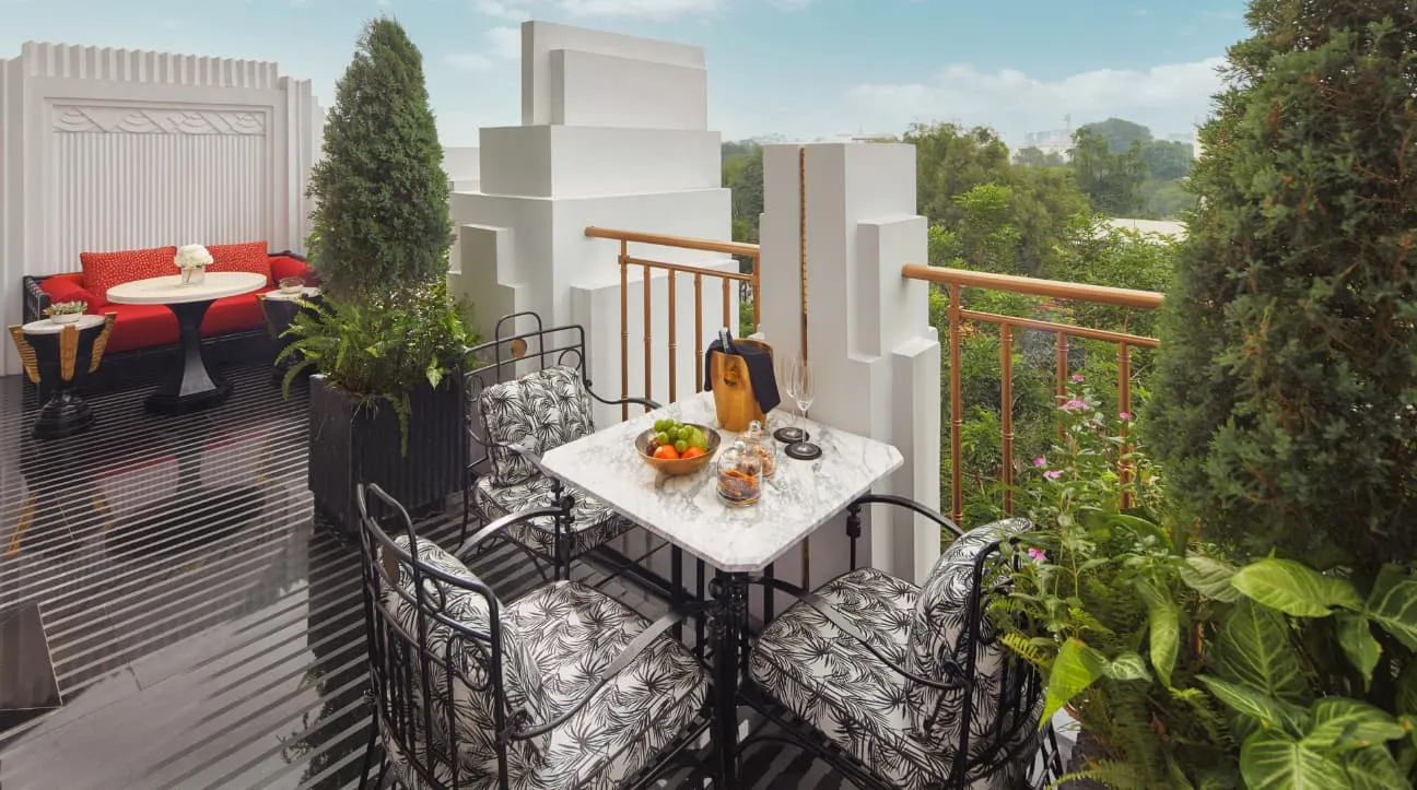 The Terrace Opera Suite’s terrace: a laid table, plants and a white Art Deco parapet