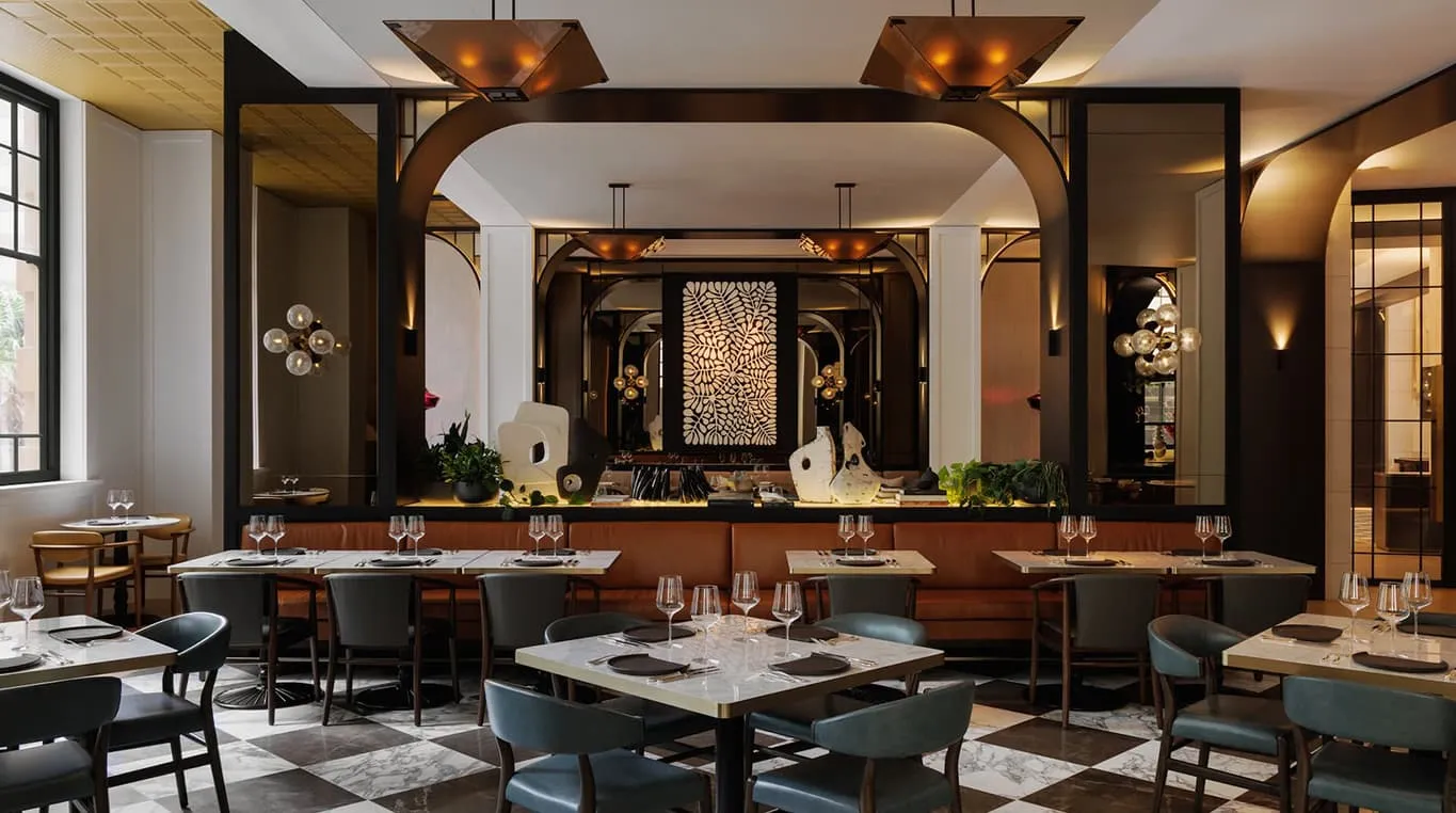 Brasserie 1930: tables on a black-and-white marble floor, an arched bar and tall windows