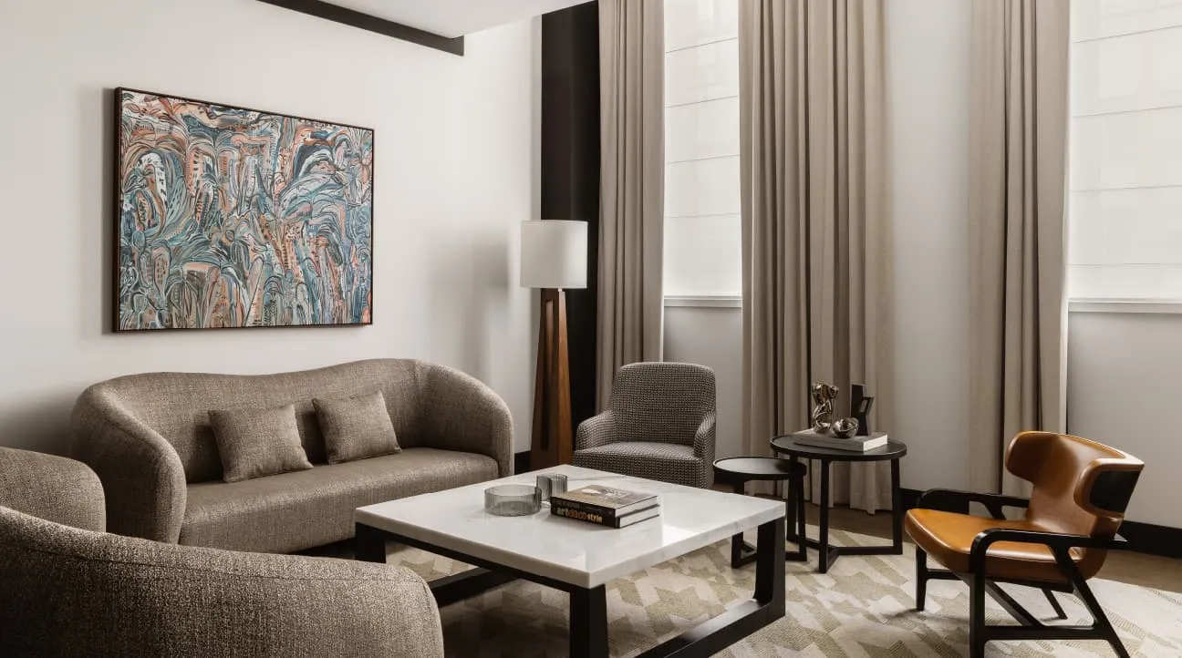 The Macquarie Suite’s sitting room: 2 sofas, a low table and a large painting