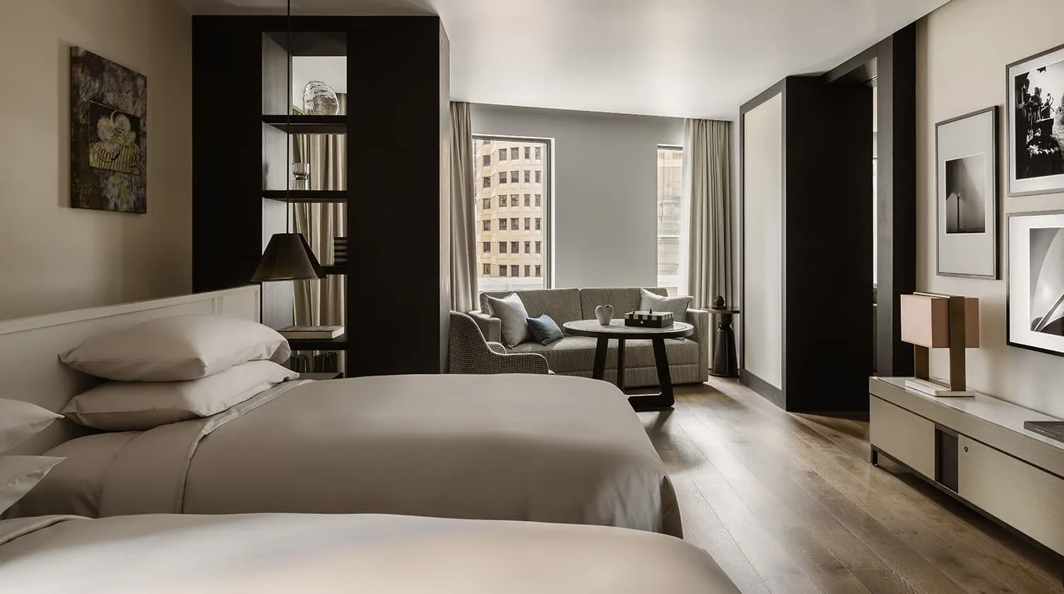 A Skyline Suite: a king bed, shelves and a sitting area by the window