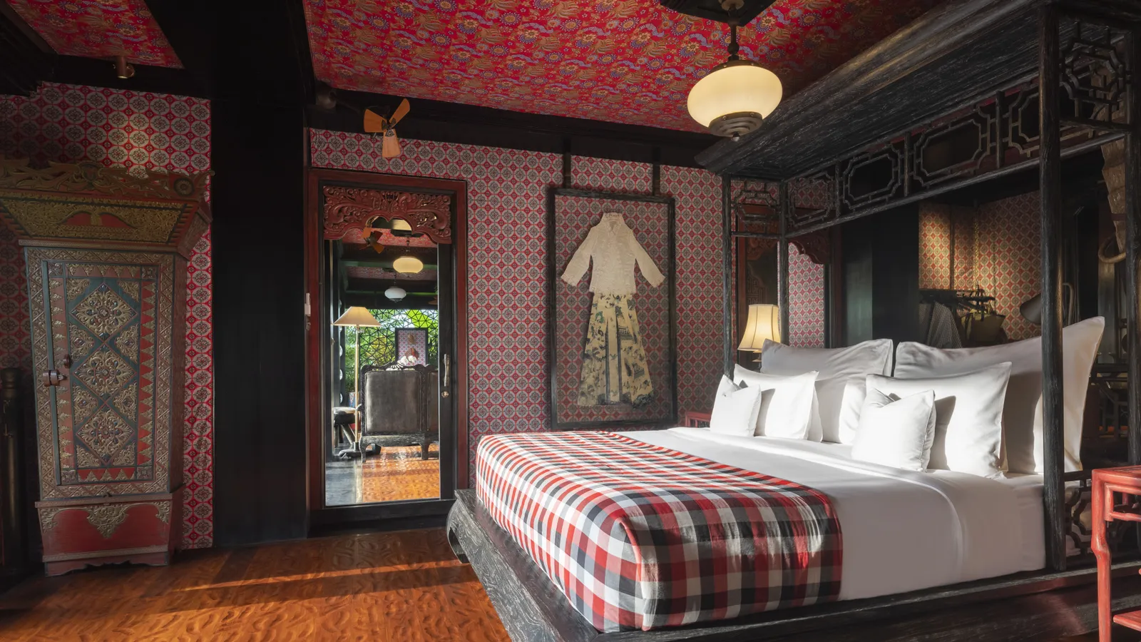 The Two Bedroom Lodge’s main bedroom: the king bed, a framed kimono on the wall and a painted wardrobe.