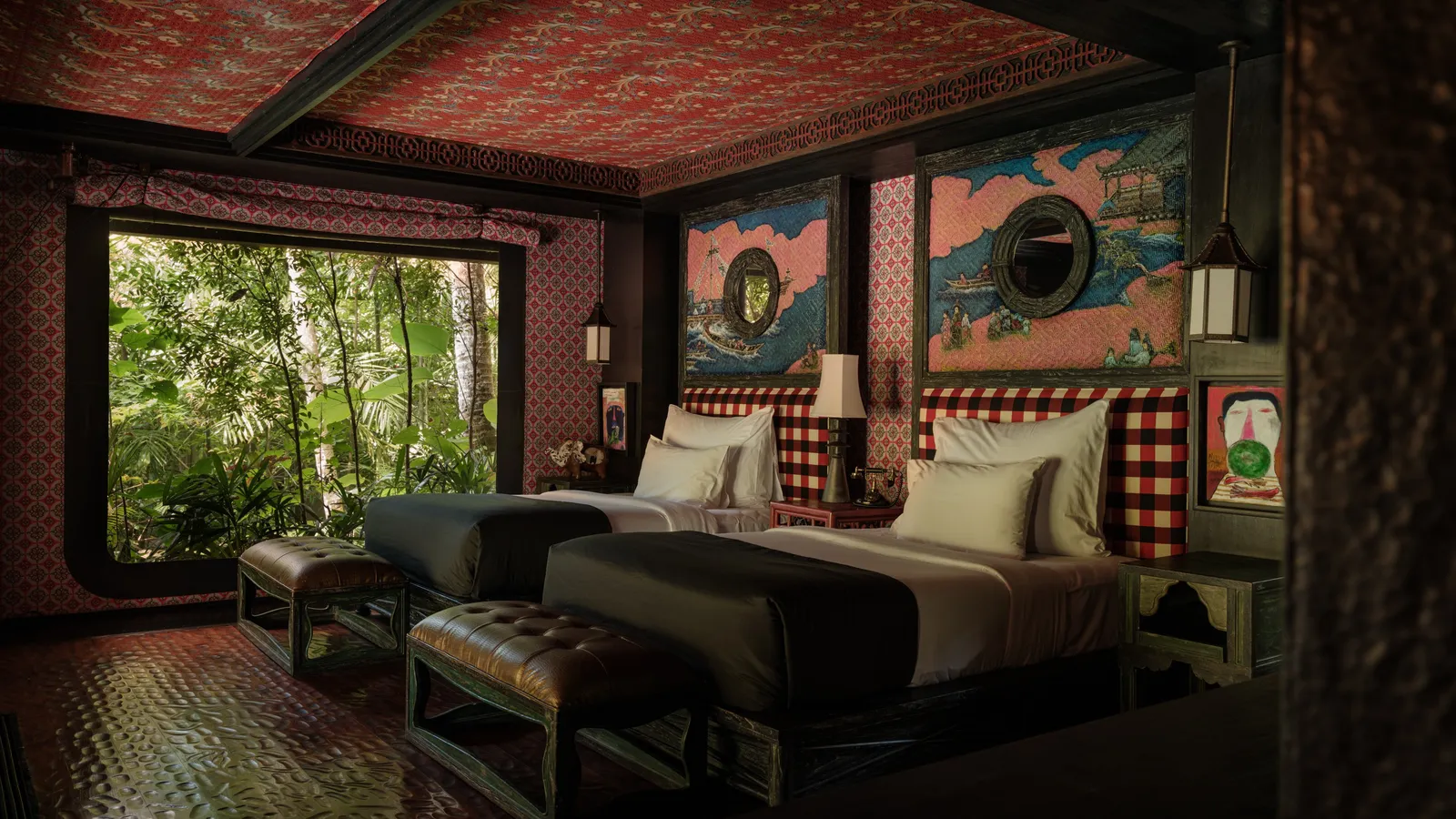 The Two Bedroom Lodge’s second bedroom: 2 single beds with benches at their feet and a large window onto the greenery.