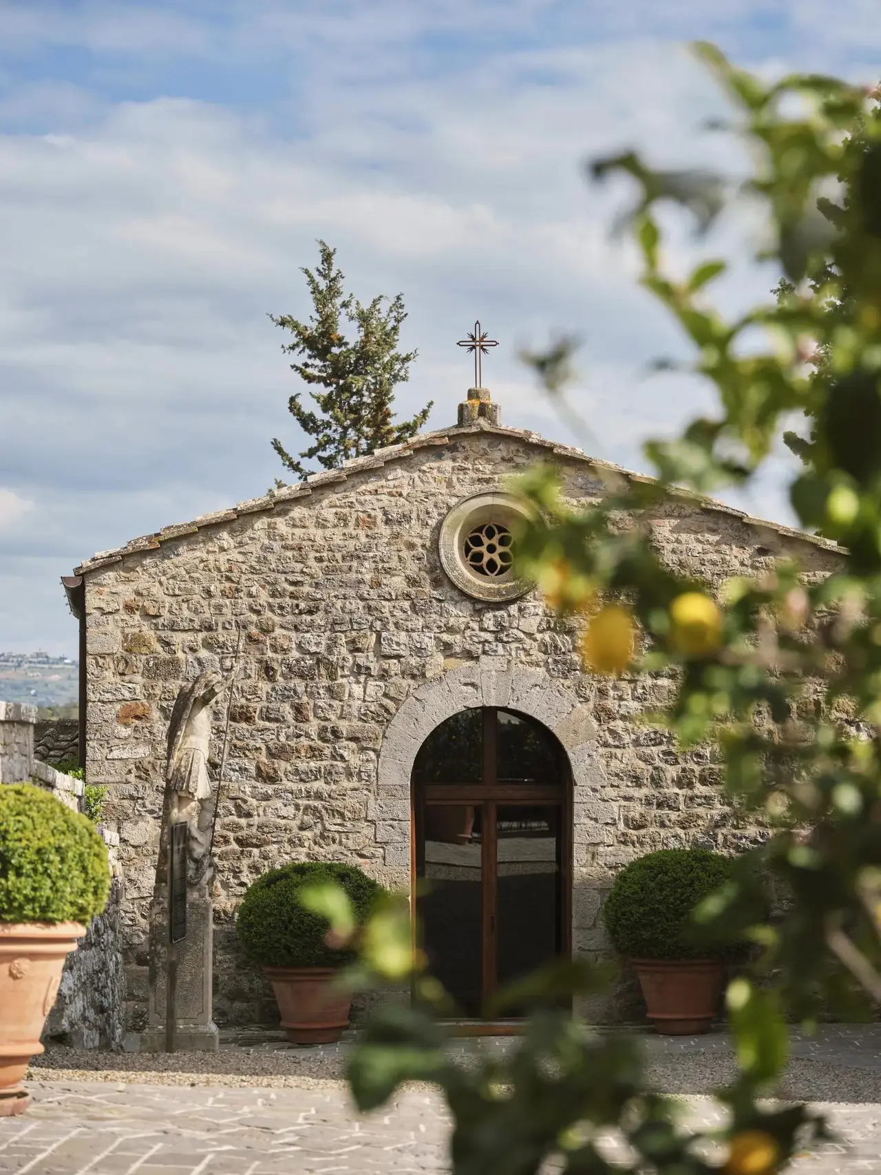 San Michele Arcangelo in the borgo: the stone front with its rose window and arched door.