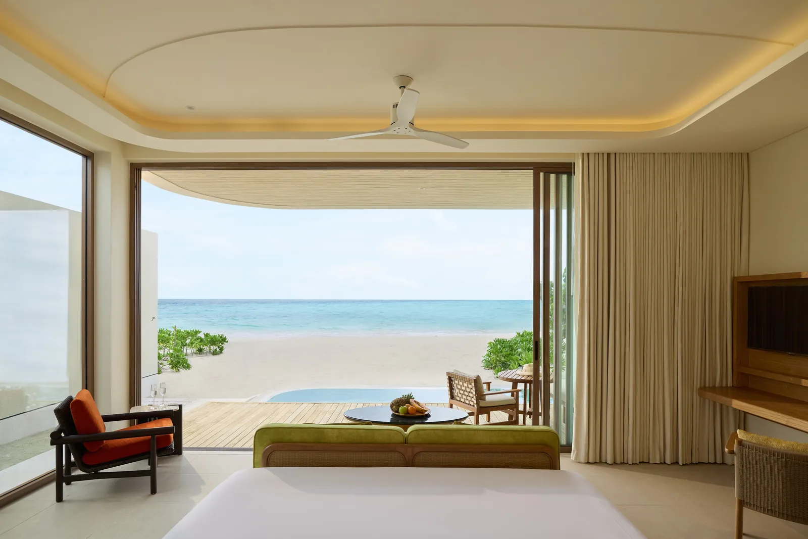 A Sunrise Beach Pool Villa: the beds facing glass doors open to the beach