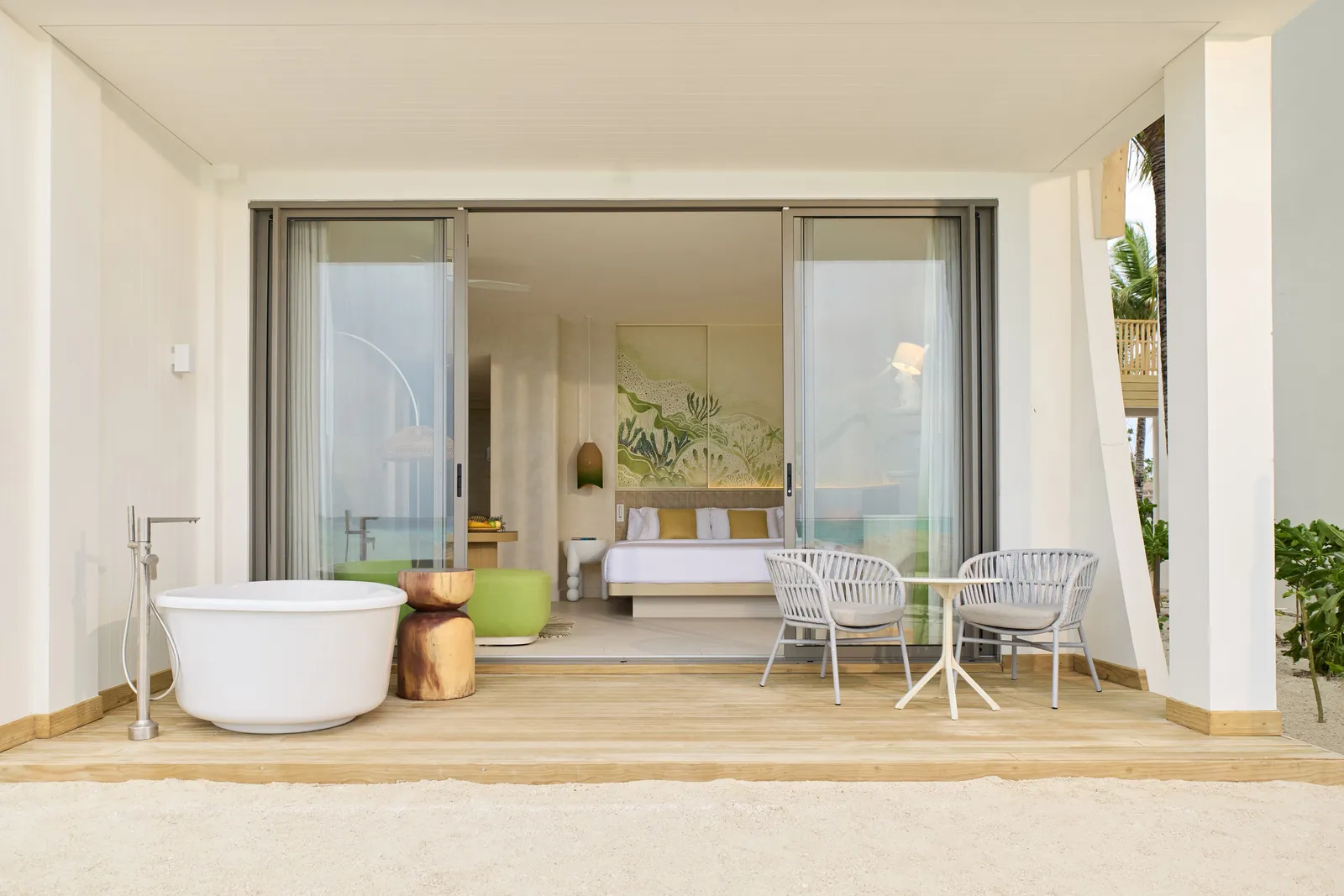 A Mirage Beachfront Room seen from the sand, the white bath on its terrace