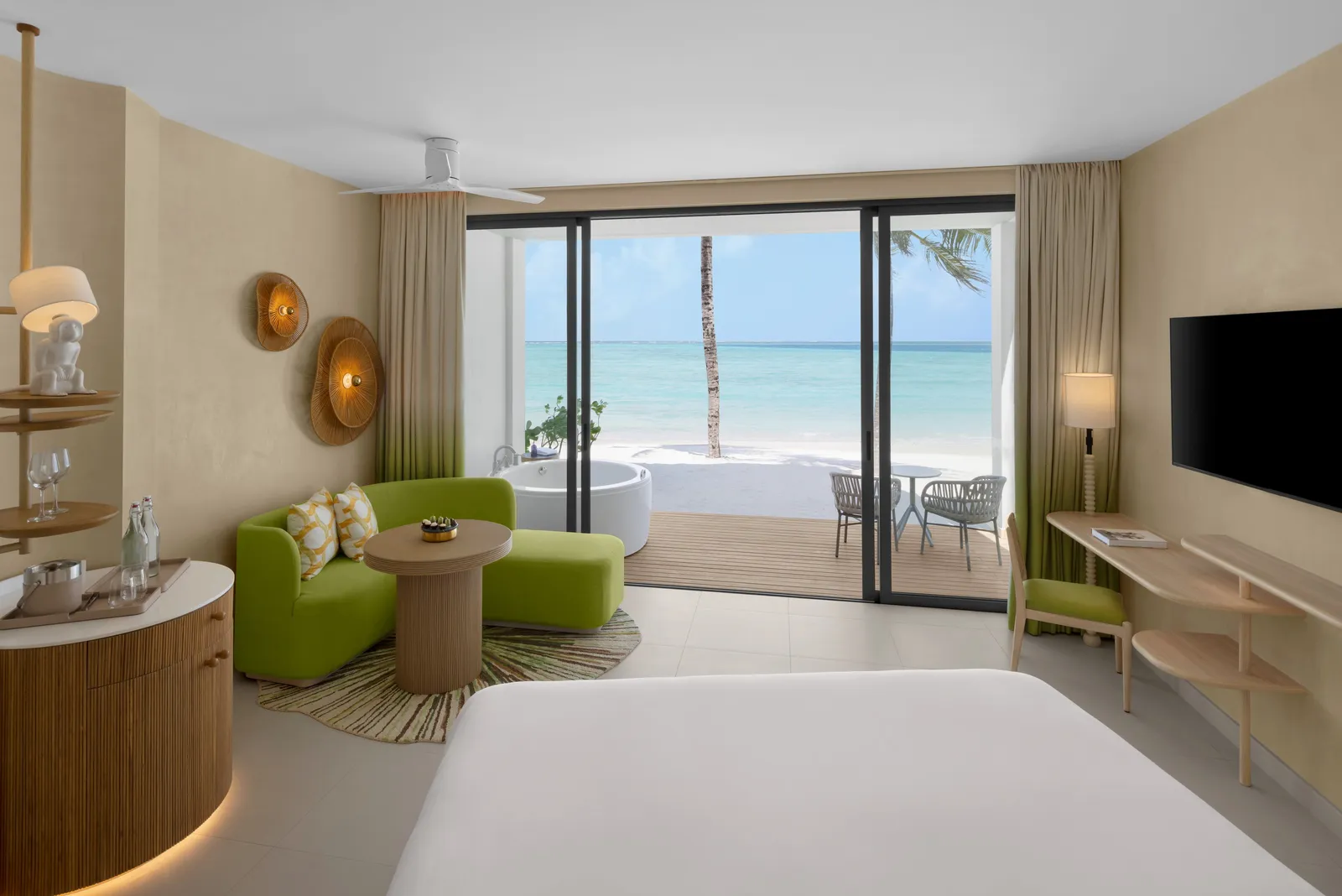 A Mirage Beachfront Room with a Jacuzzi, the room open to the beach and the palms