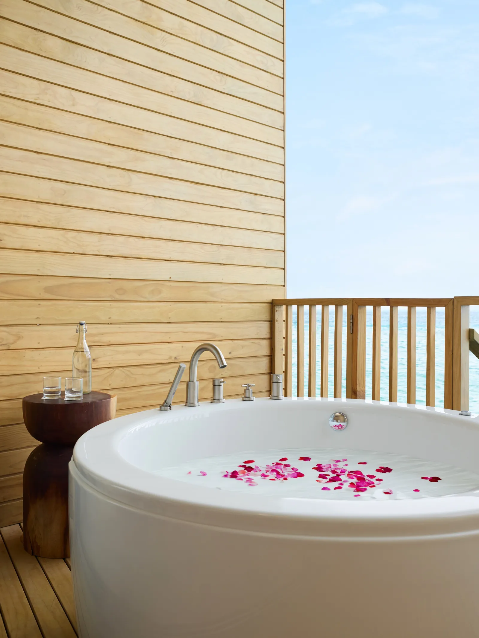 The petal-strewn Jacuzzi on the deck of a Mirage Overwater Sunset Villa