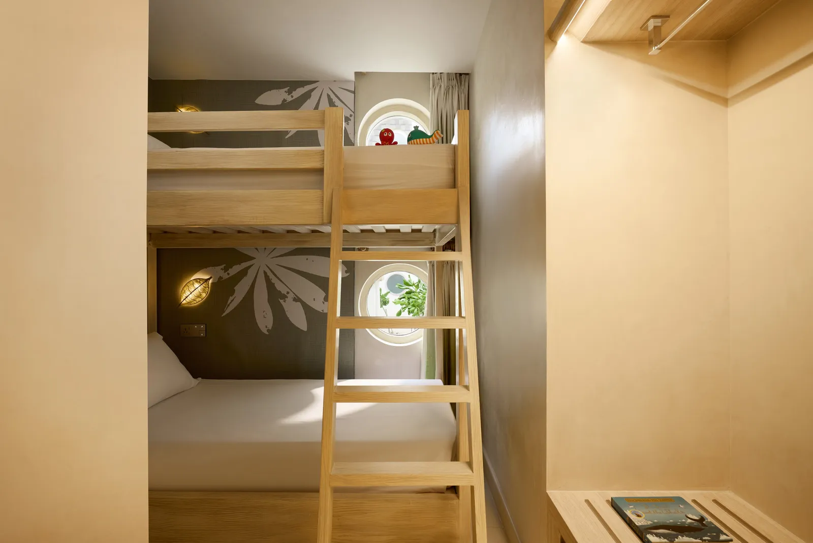The bunk beds of a Mirage Panoramic Room, a porthole in the wall