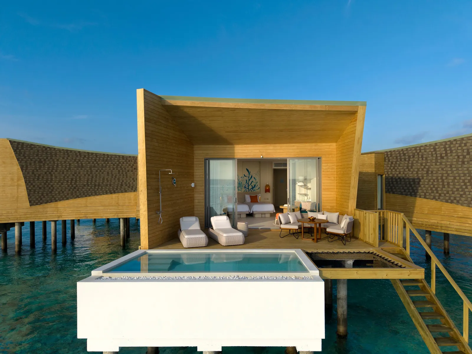 A Mirage Overwater Sunset Pool Villa seen from the lagoon, the pool on its deck