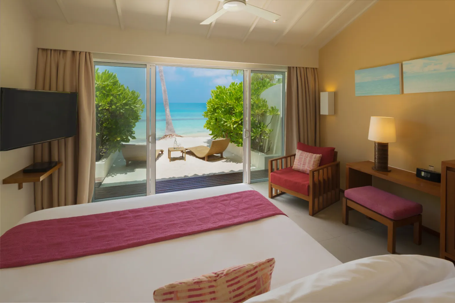 A Lagoon View Beach Villa with Swirl Pool: from the bed you step out to a terrace with loungers, then the sand and the lagoon.