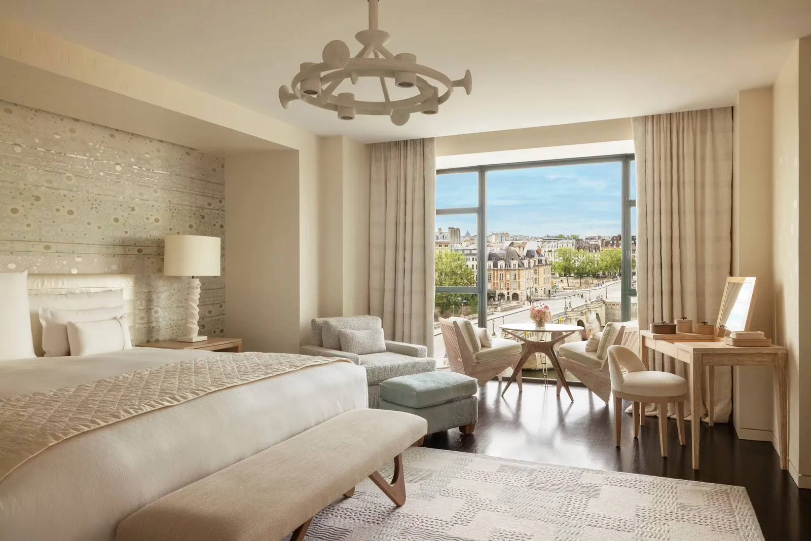 A bedroom with a bed, sofa and windows