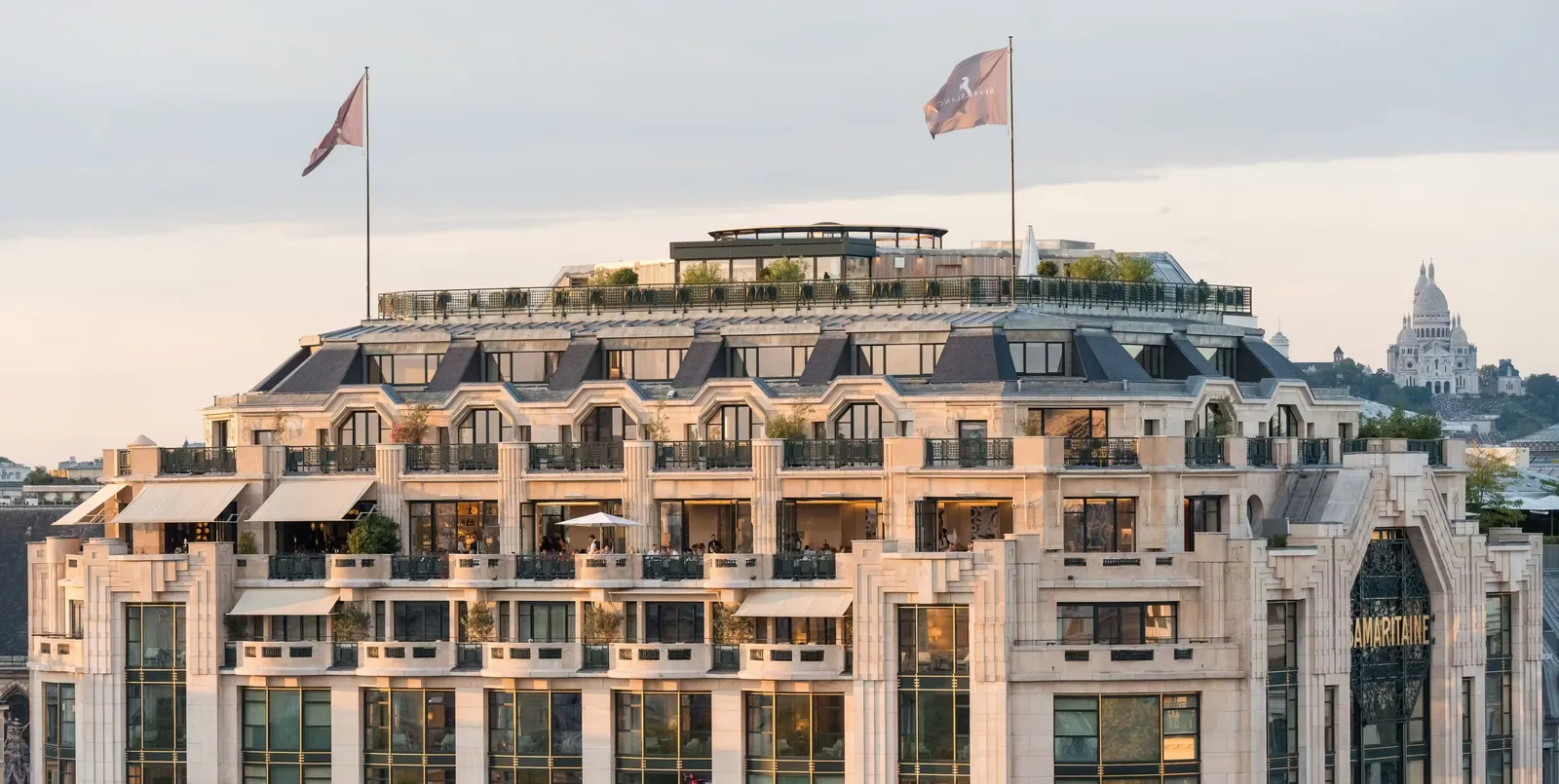 Upper floors of the building with flags and Paris rooftops