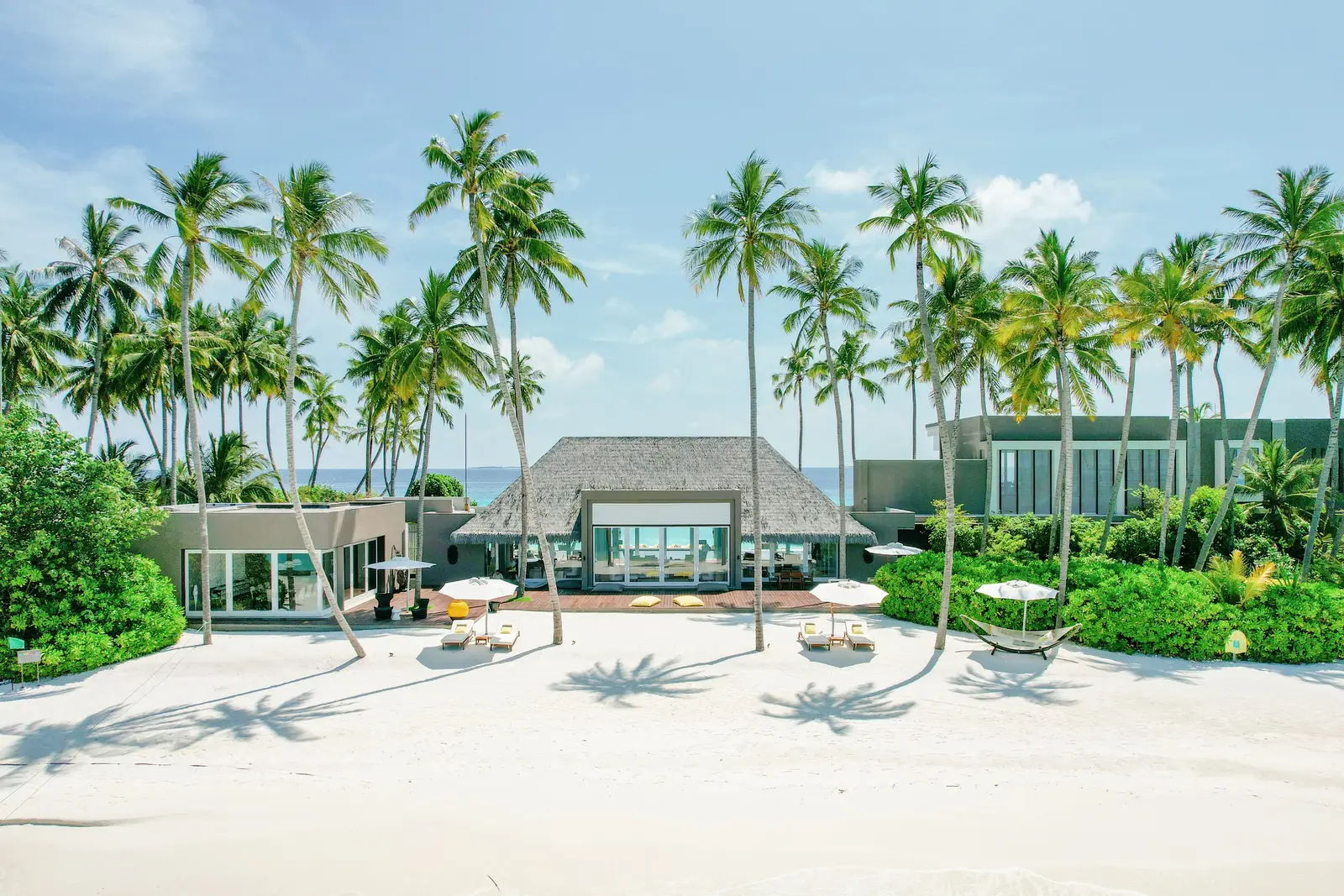 The Private Island: the main house on the beach among the palms