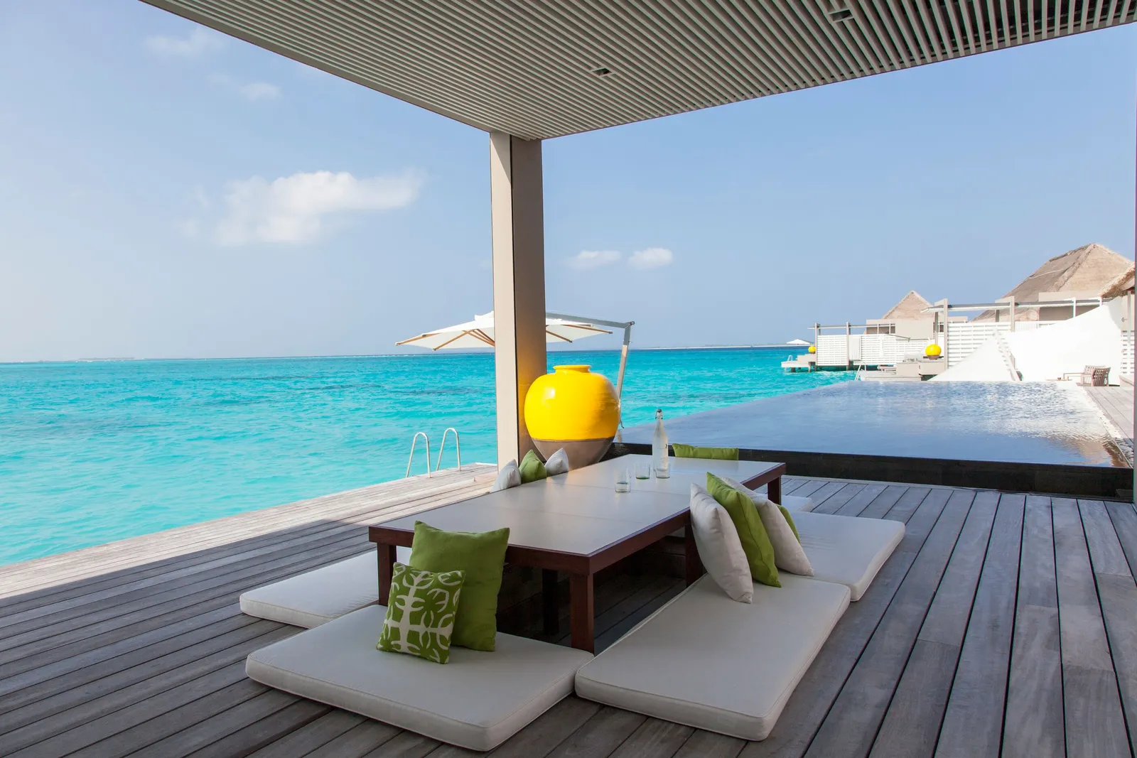 Water Villa: the deck with its parasol and cushions, the open sea ahead