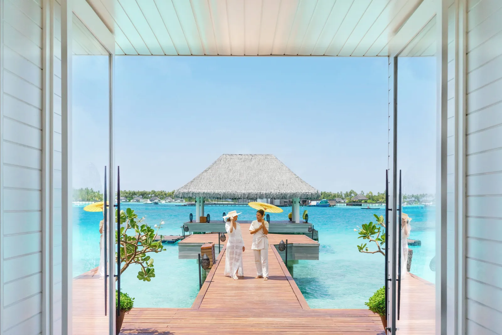 From the spa’s threshold, the jetty crossing the lagoon to a pavilion