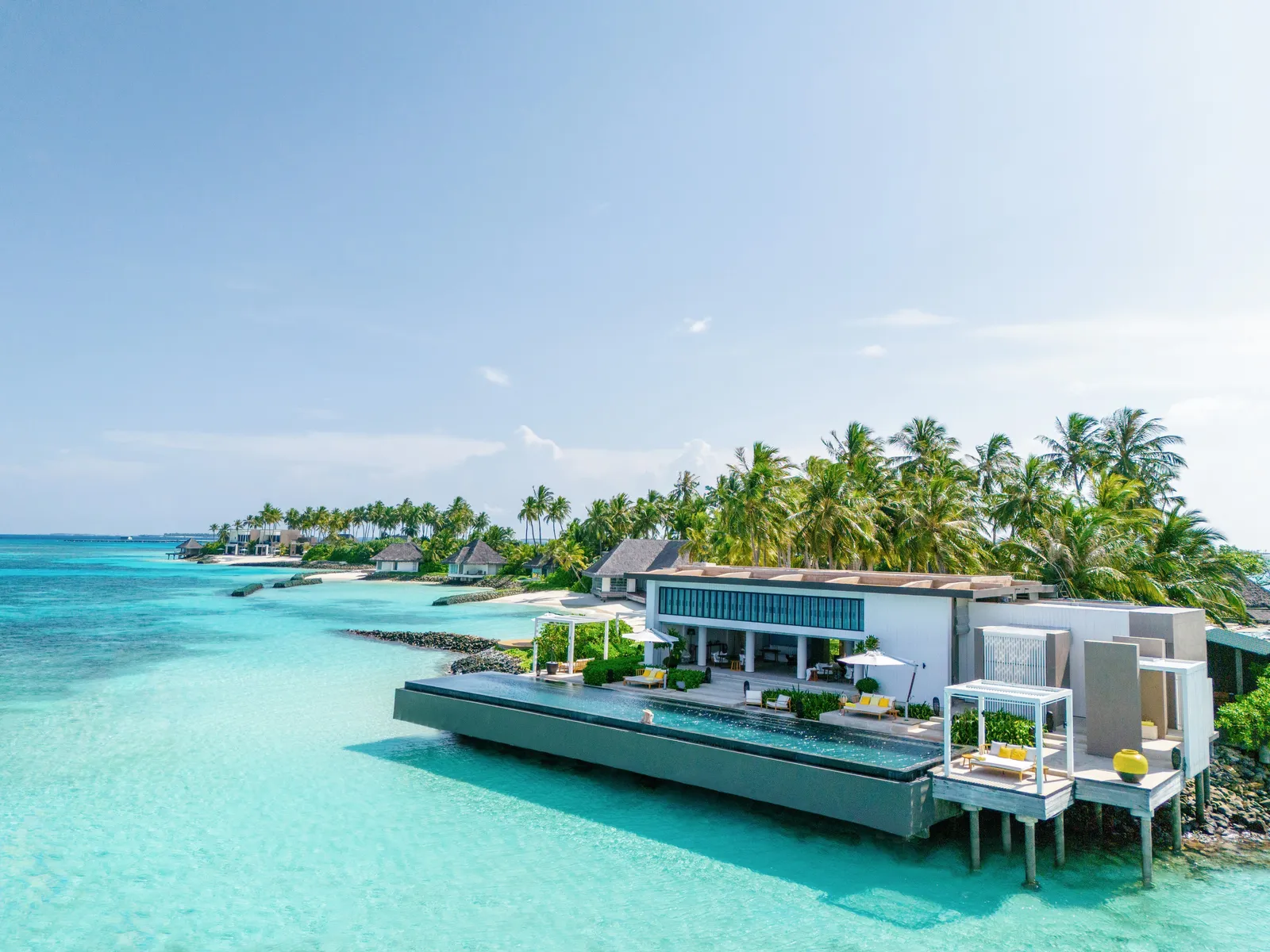 A water villa with its long pool facing the open sea