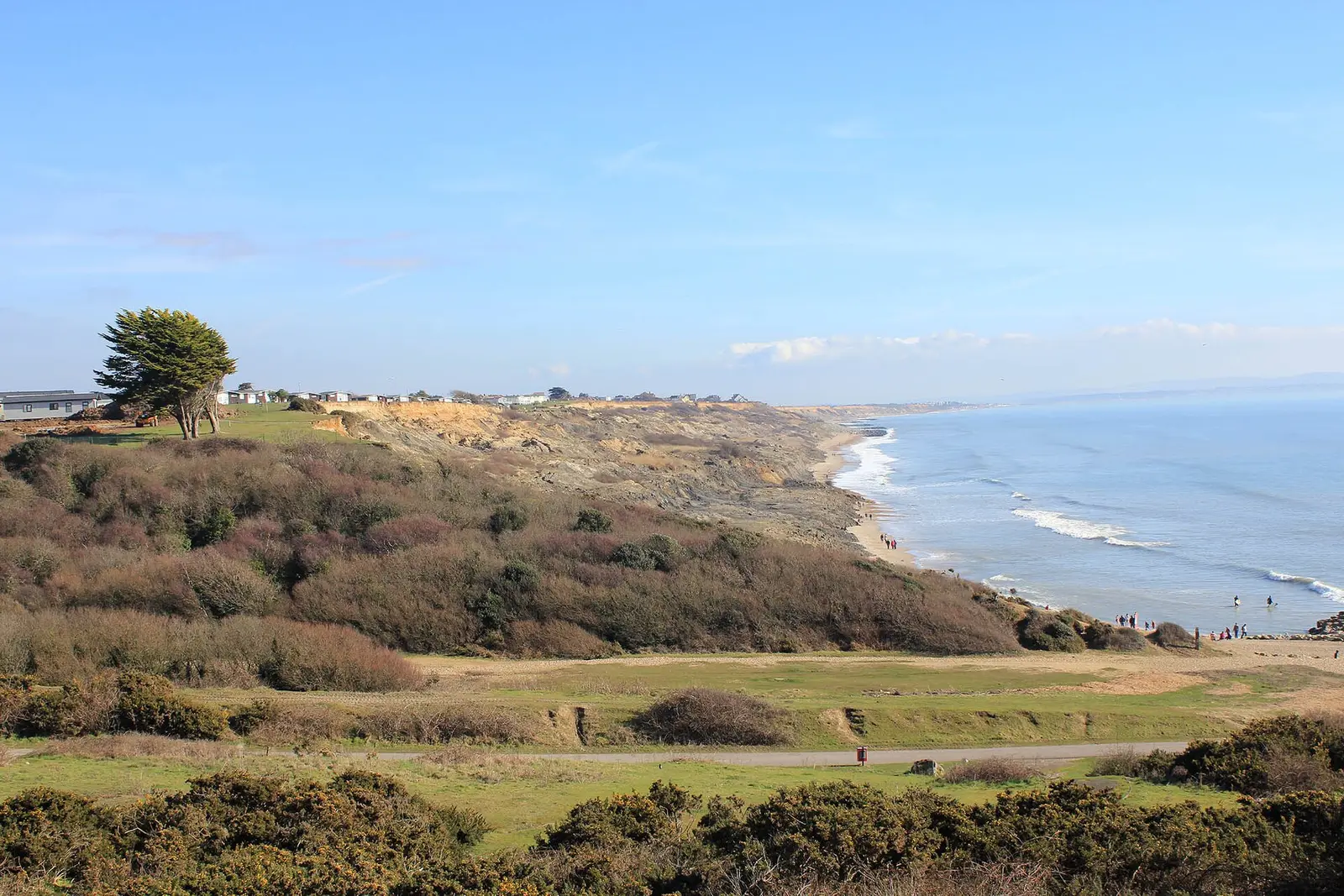 The scrub of Chewton Bunny and the coast towards Barton-on-Sea under a clear sky