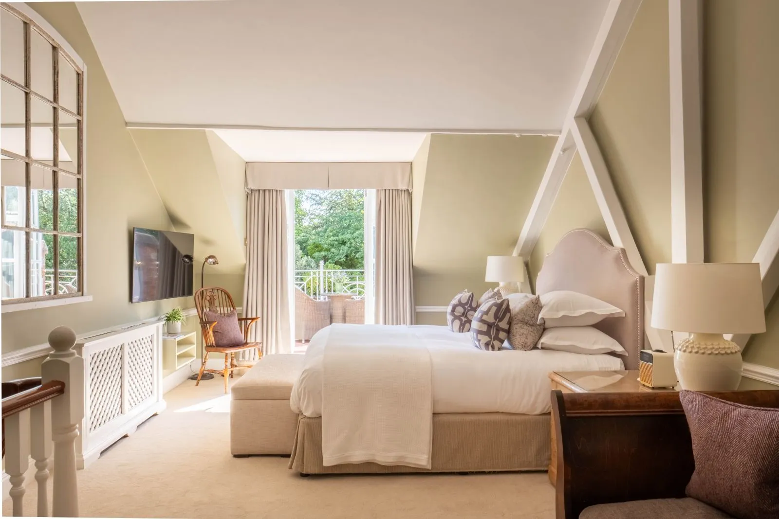 The Coach House Duplex’s loft bedroom with a door onto the small terrace