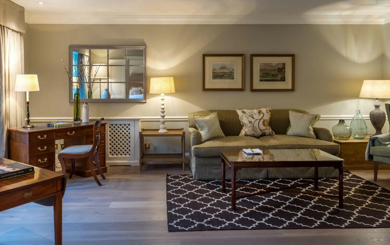 A Hotel Suite’s sitting room with sofa, desk and coffee table