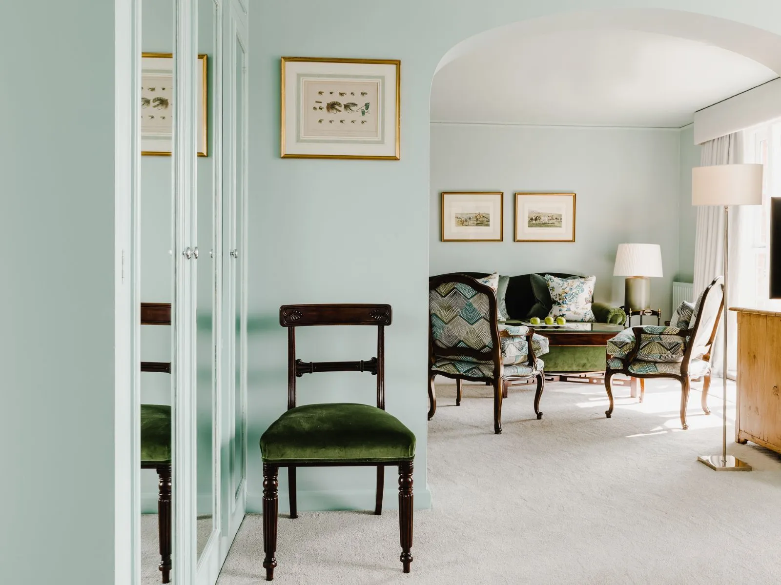 A Junior Suite’s sitting area, armchairs and the arch into the bedroom