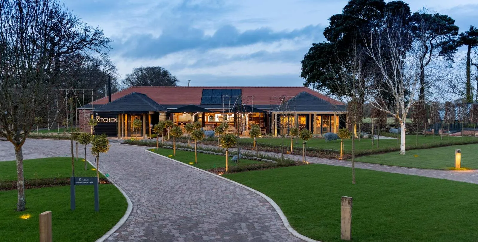 The Kitchen at dusk, with the curving path from the house