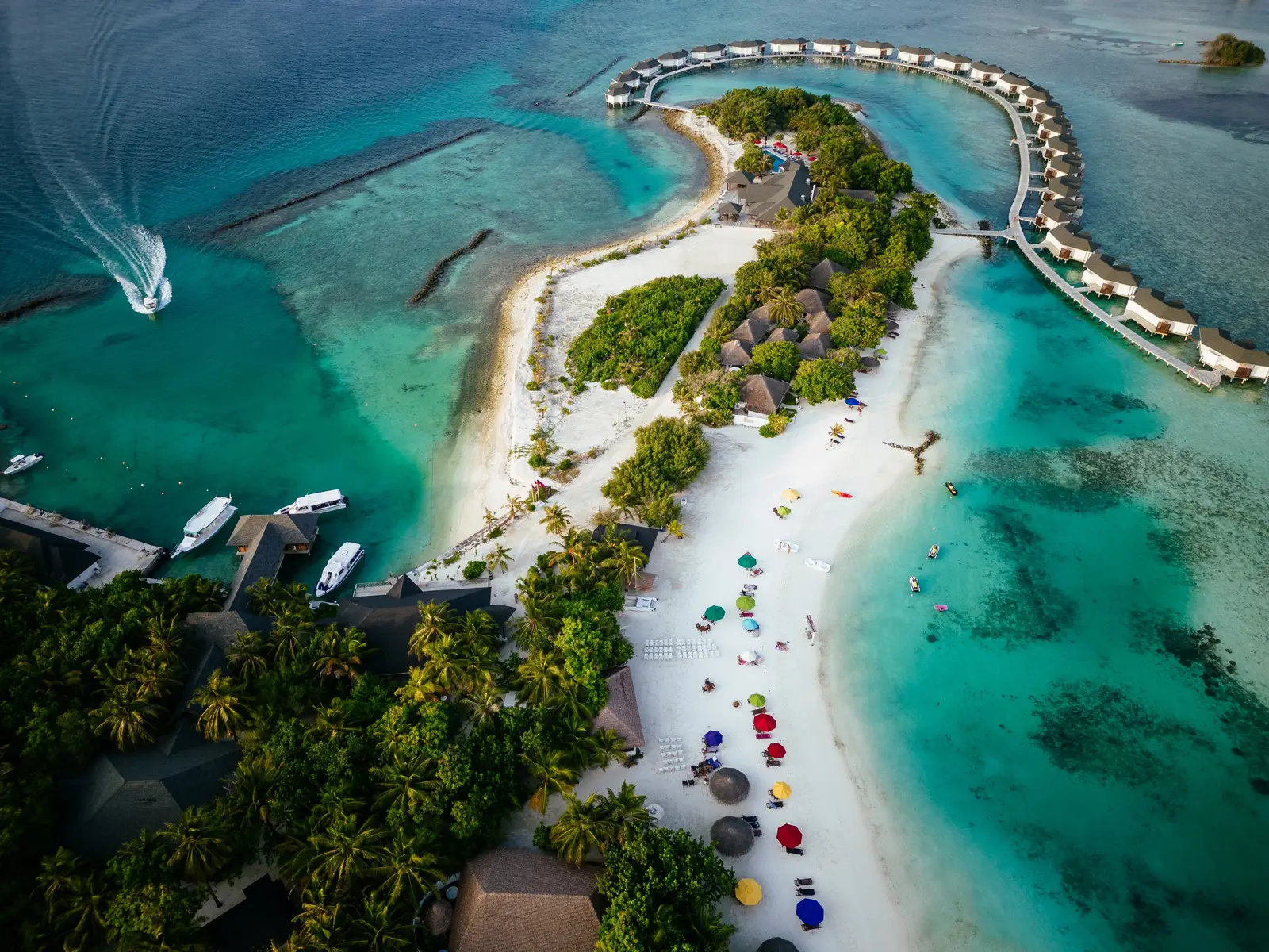 Dhonveli’s beach and the jetty of water bungalows from above