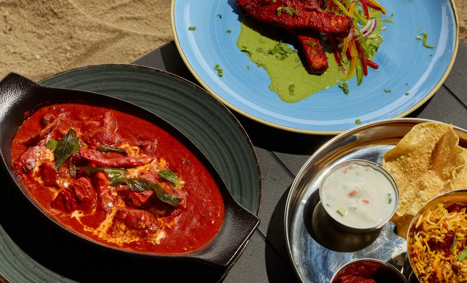 Curry dishes, rice and Indian bread served at Dalchini