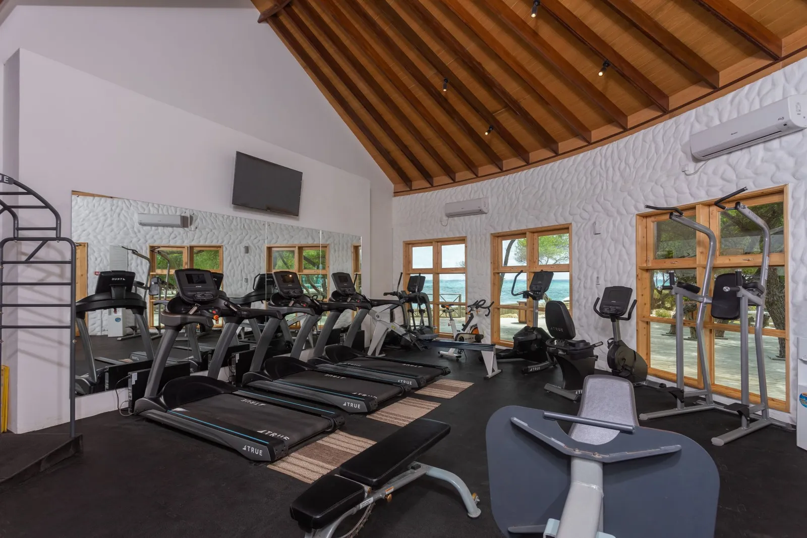 Treadmills in the gym beneath its timber roof