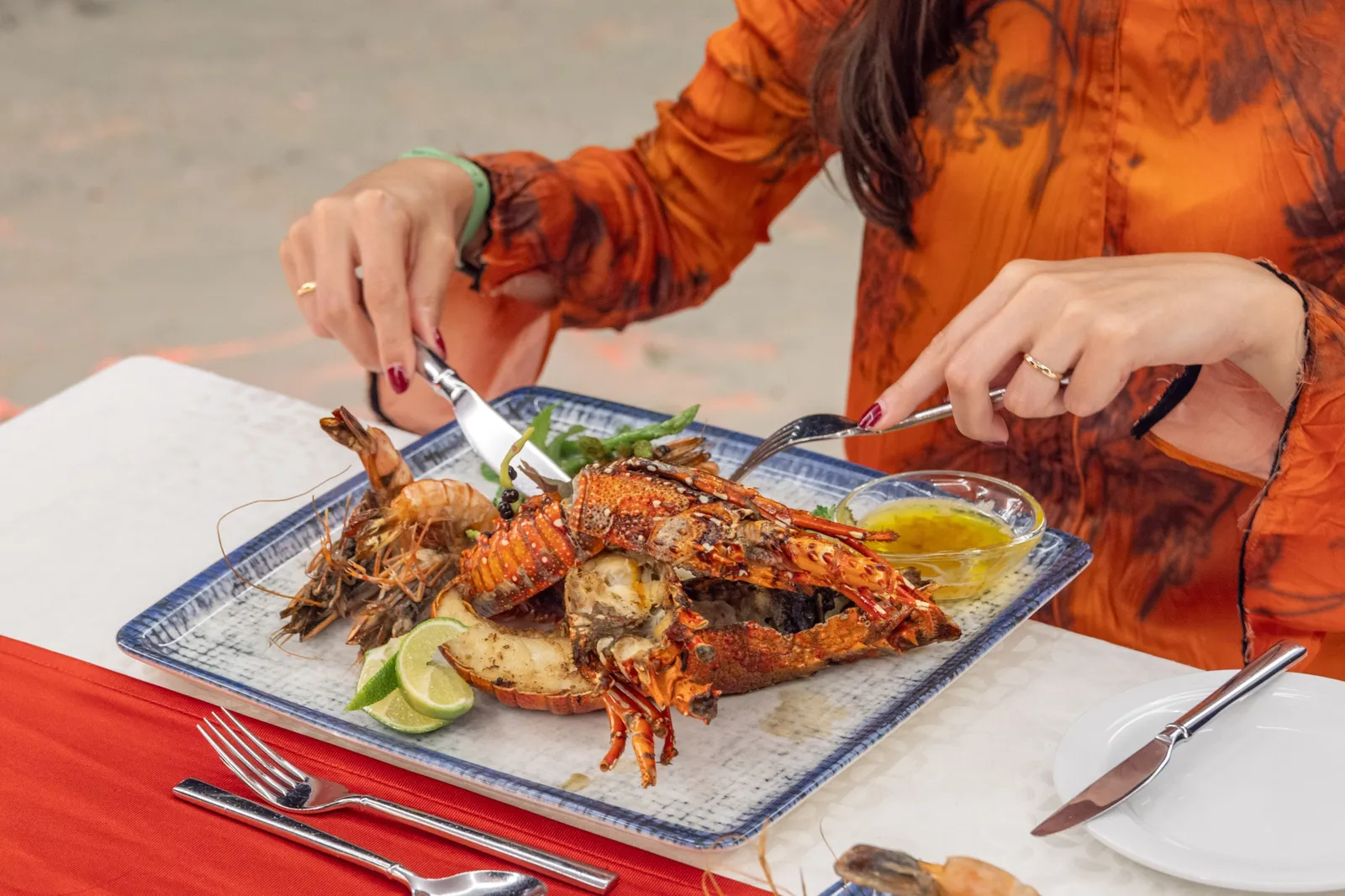 A lobster dish being cut at the table
