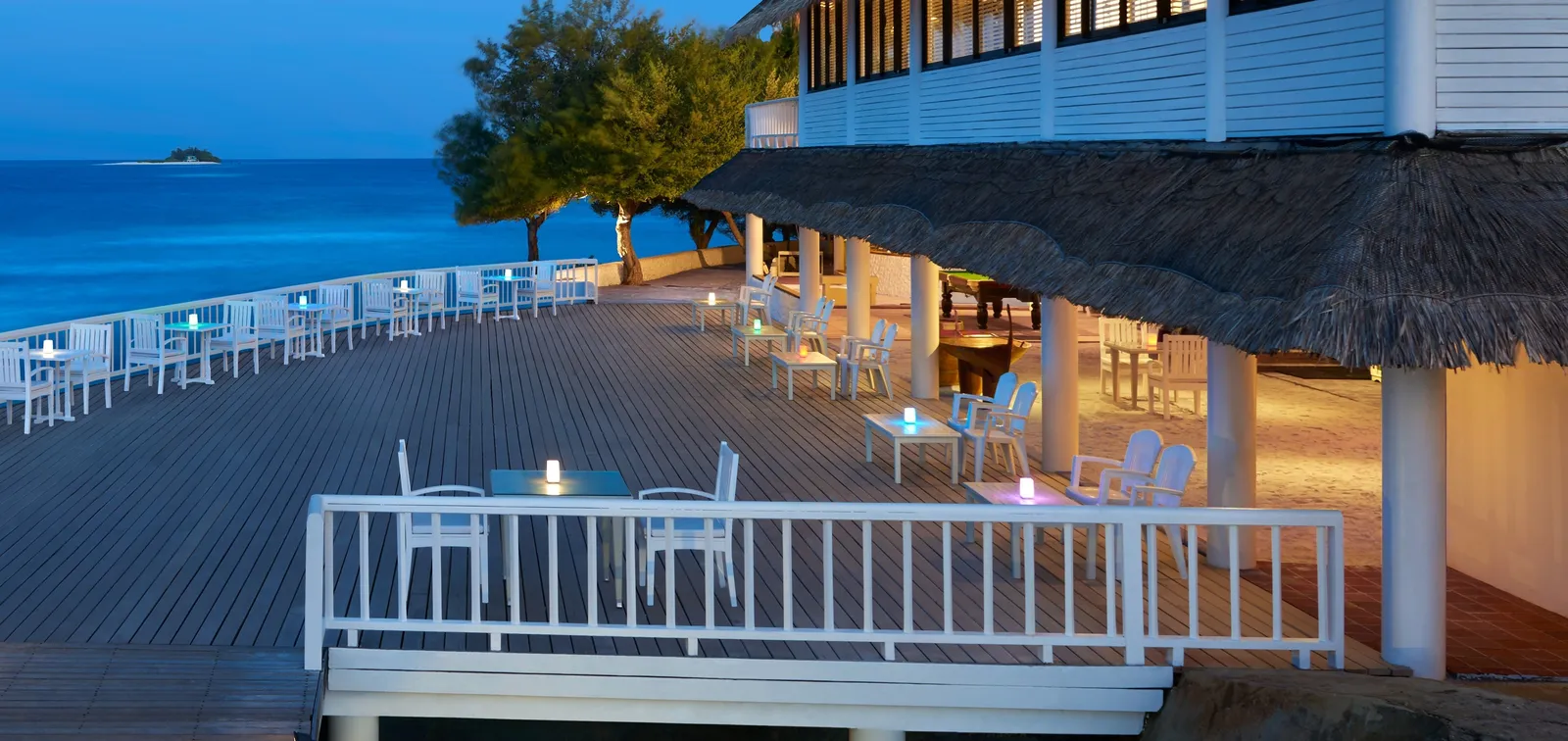 The Raalhu Bar’s terrace in the evening, its white railing above the sea