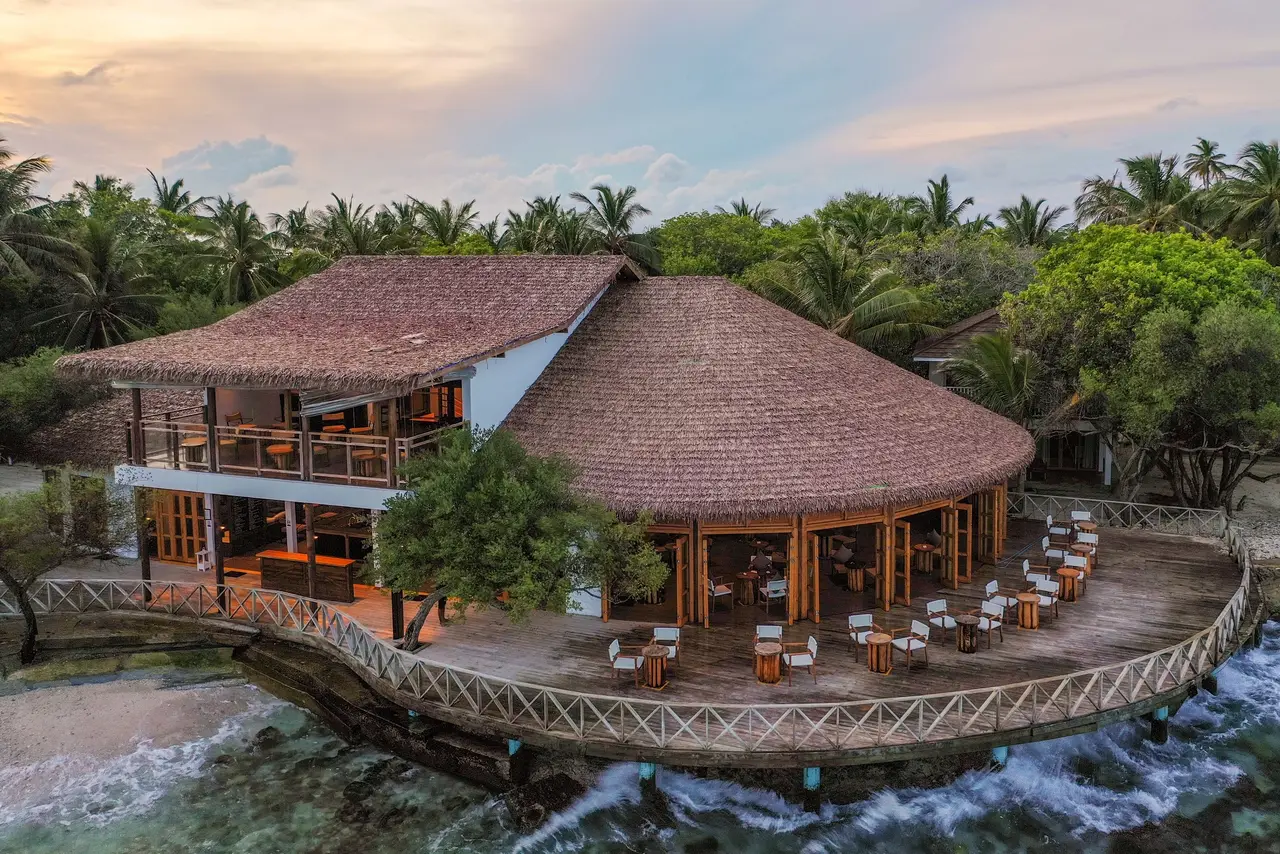 Raiyvilla at sunset, the thatched pavilion on the edge of the island