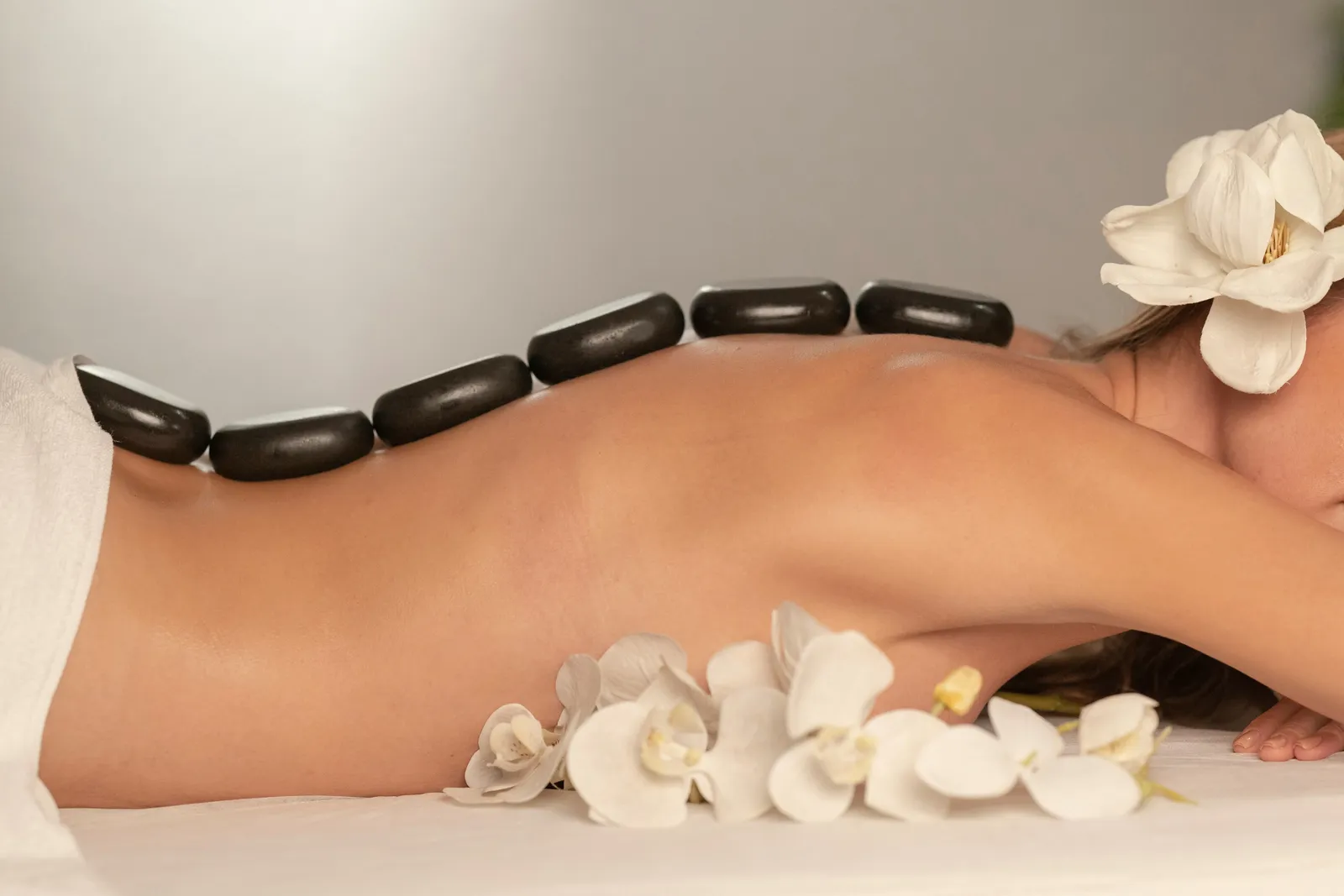 A hot-stone treatment on the back, with white flowers