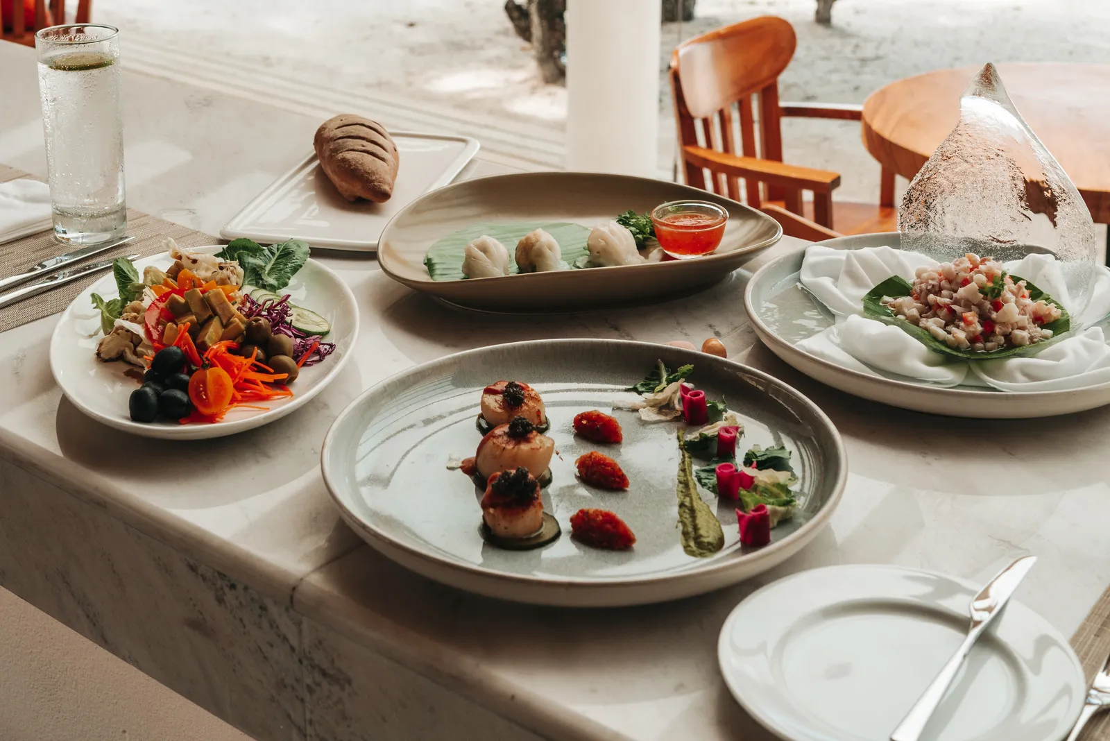 A table at Corals: seafood and vegetable starters on ceramic plates