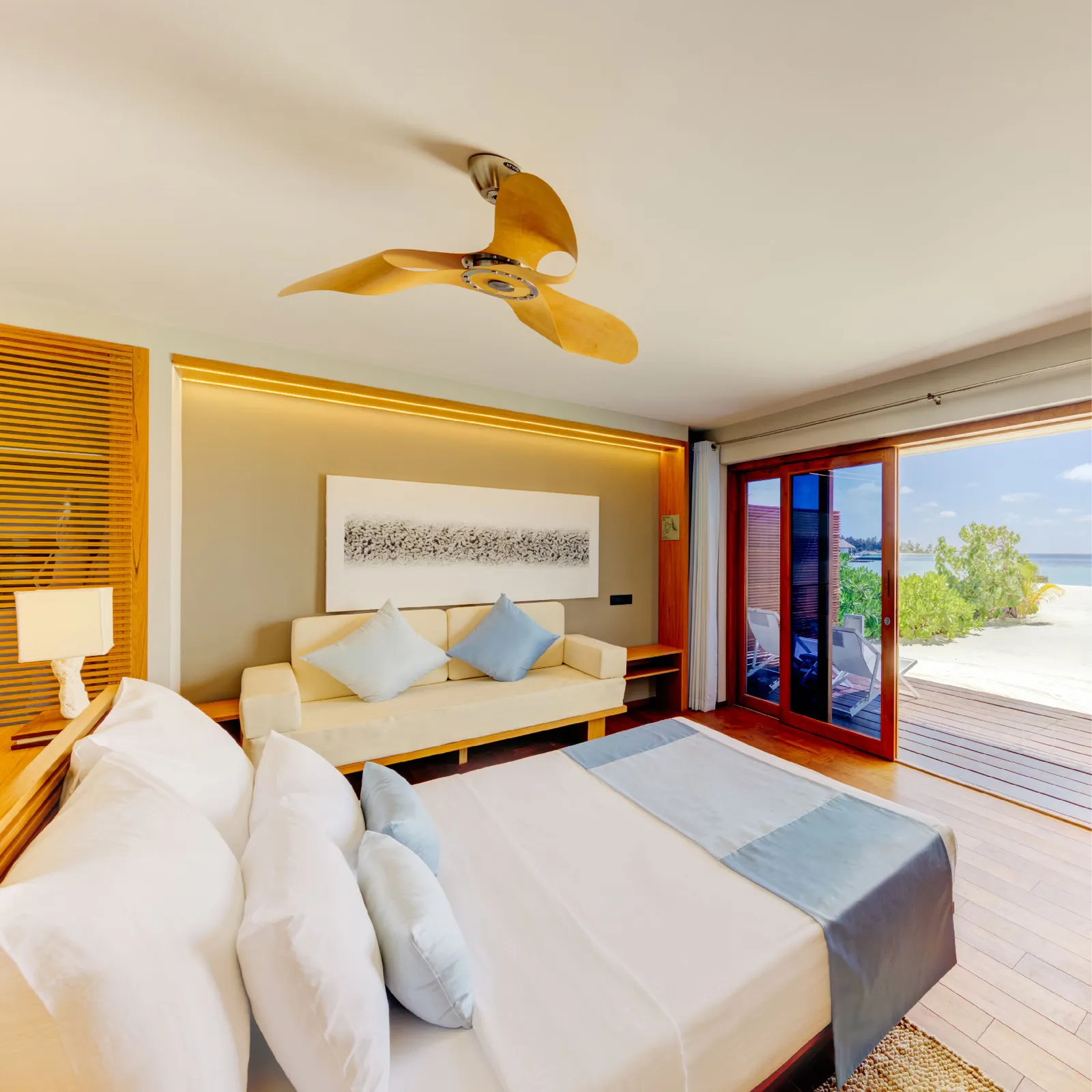 A Beach Bungalow interior, with its bed and doors opening to the terrace
